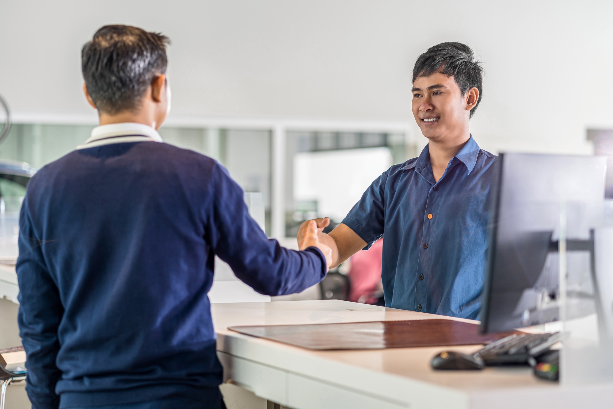 Asian Mechanic handshake with the customer and leader in maintenance service