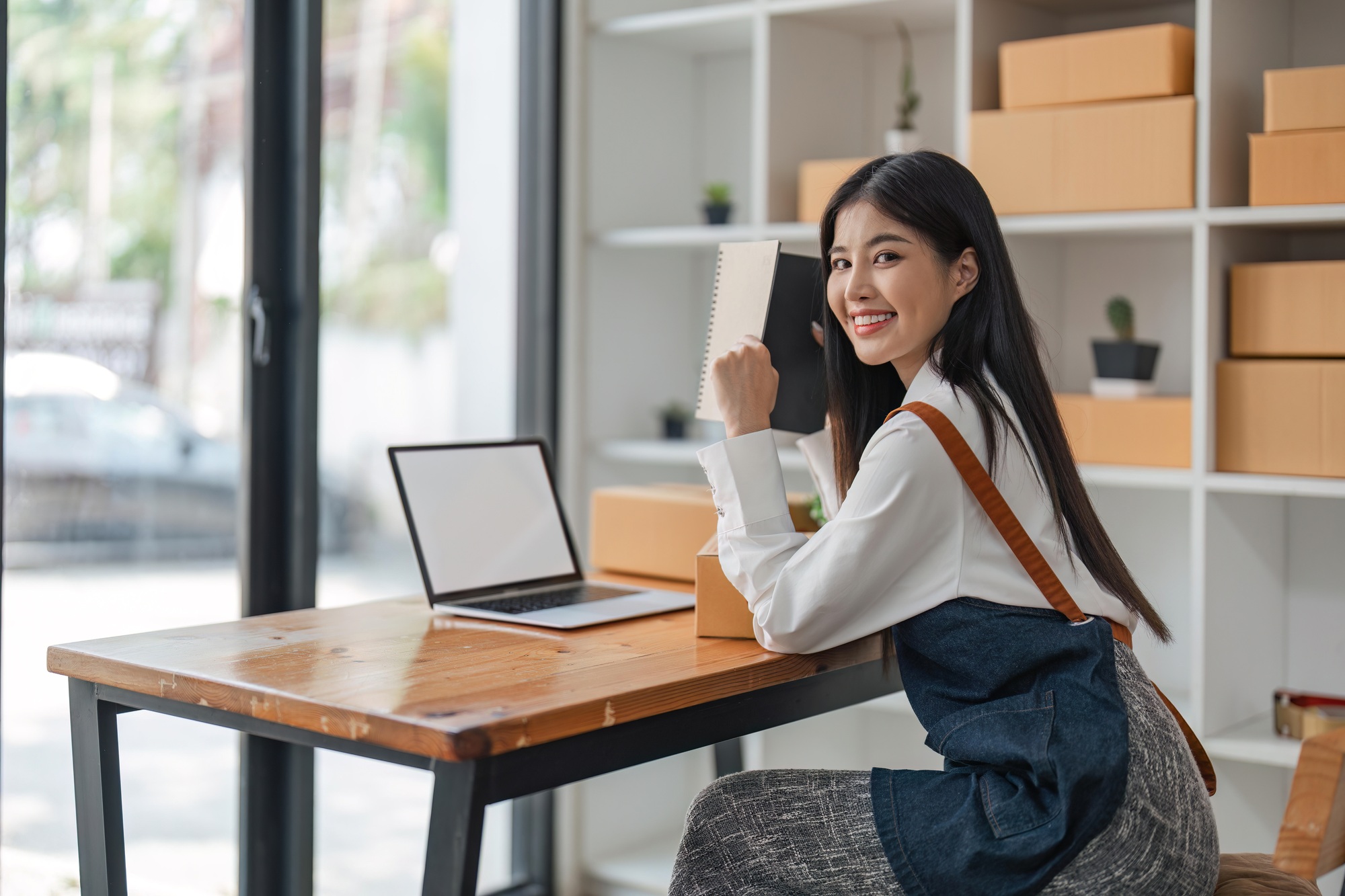 Asian woman online store business owner, online shop owner working from home, products for sale on