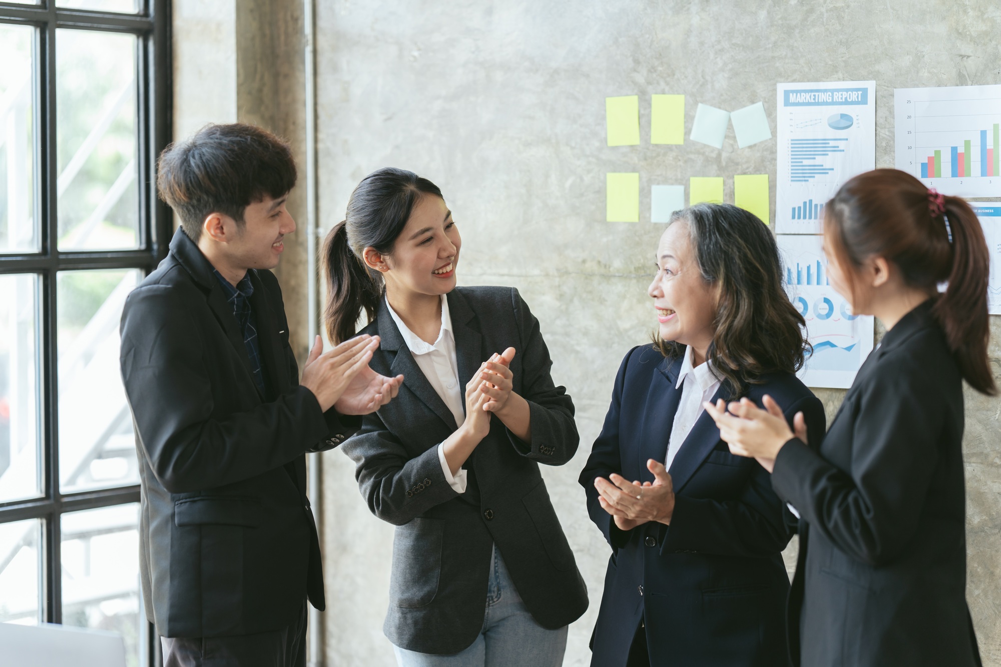 Audience clapping at business seminar, Friendly diverse employees congratulating businesswoman with