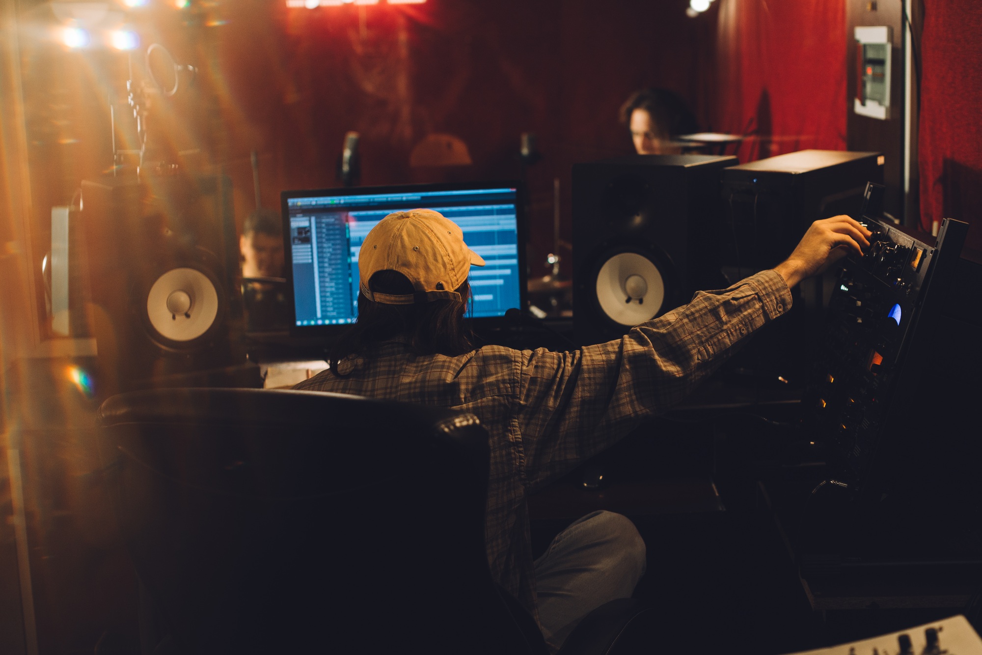 Audio engineer fine-tuning settings on a mixing console