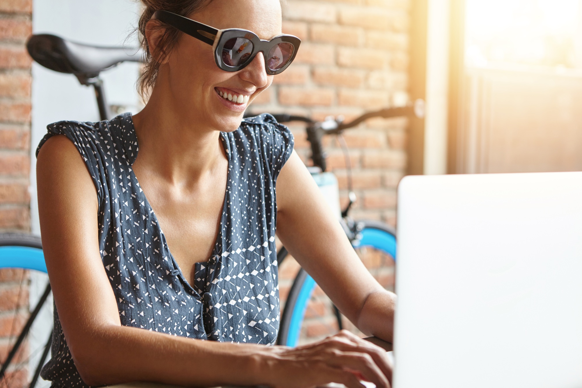 Beautiful female blogger editing webcam video to post it on her blog for her followers, looking and
