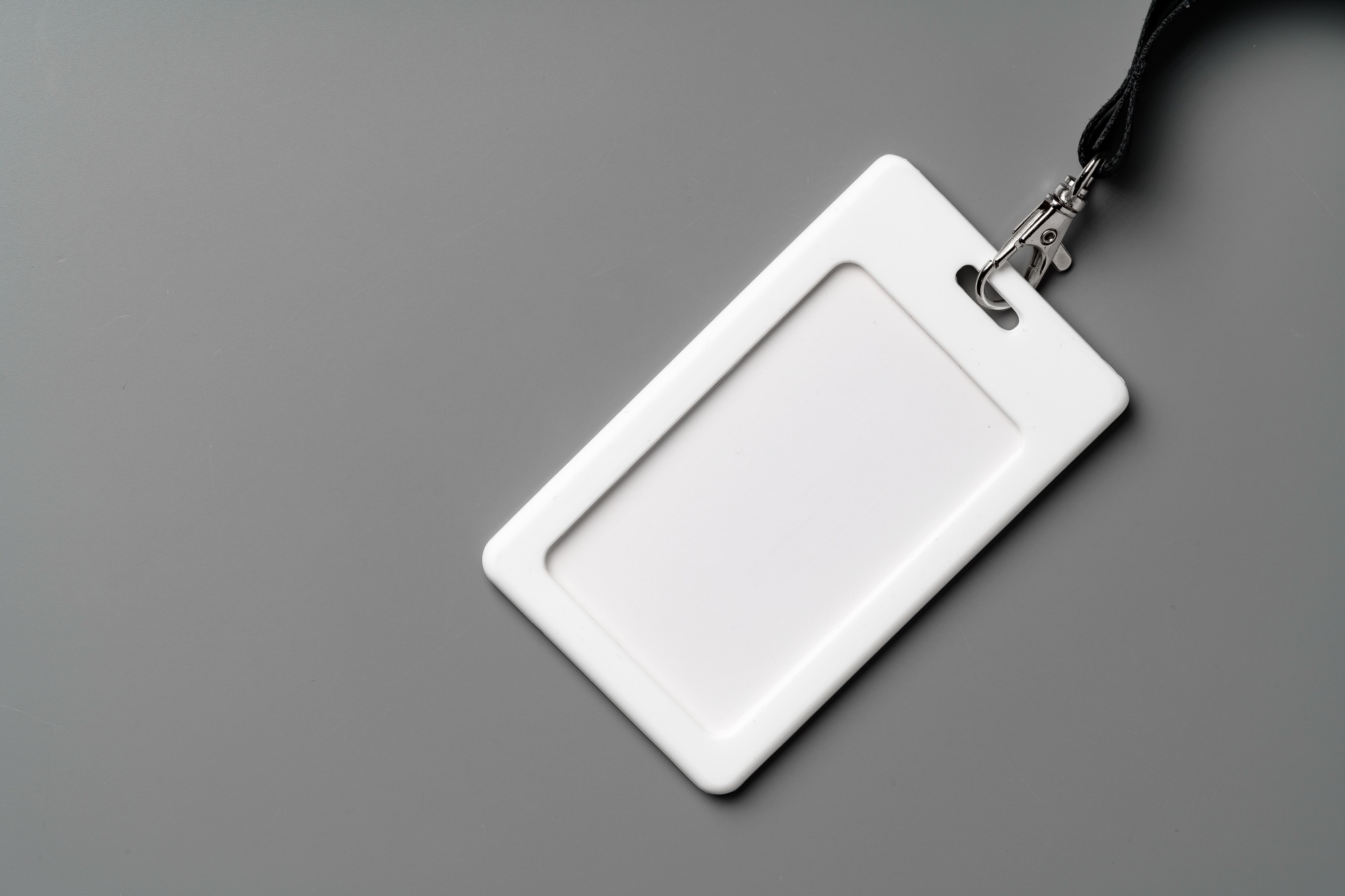 Blank nametag on gray background copy space