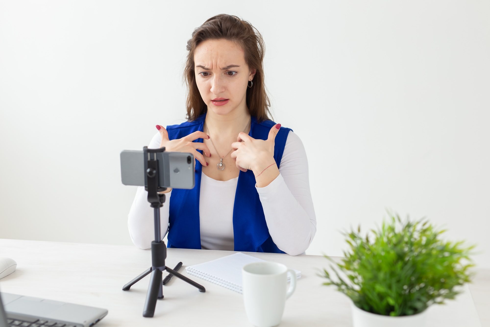Blogging, broadcast and people concept - woman blogger is talking to the camera for her spectators