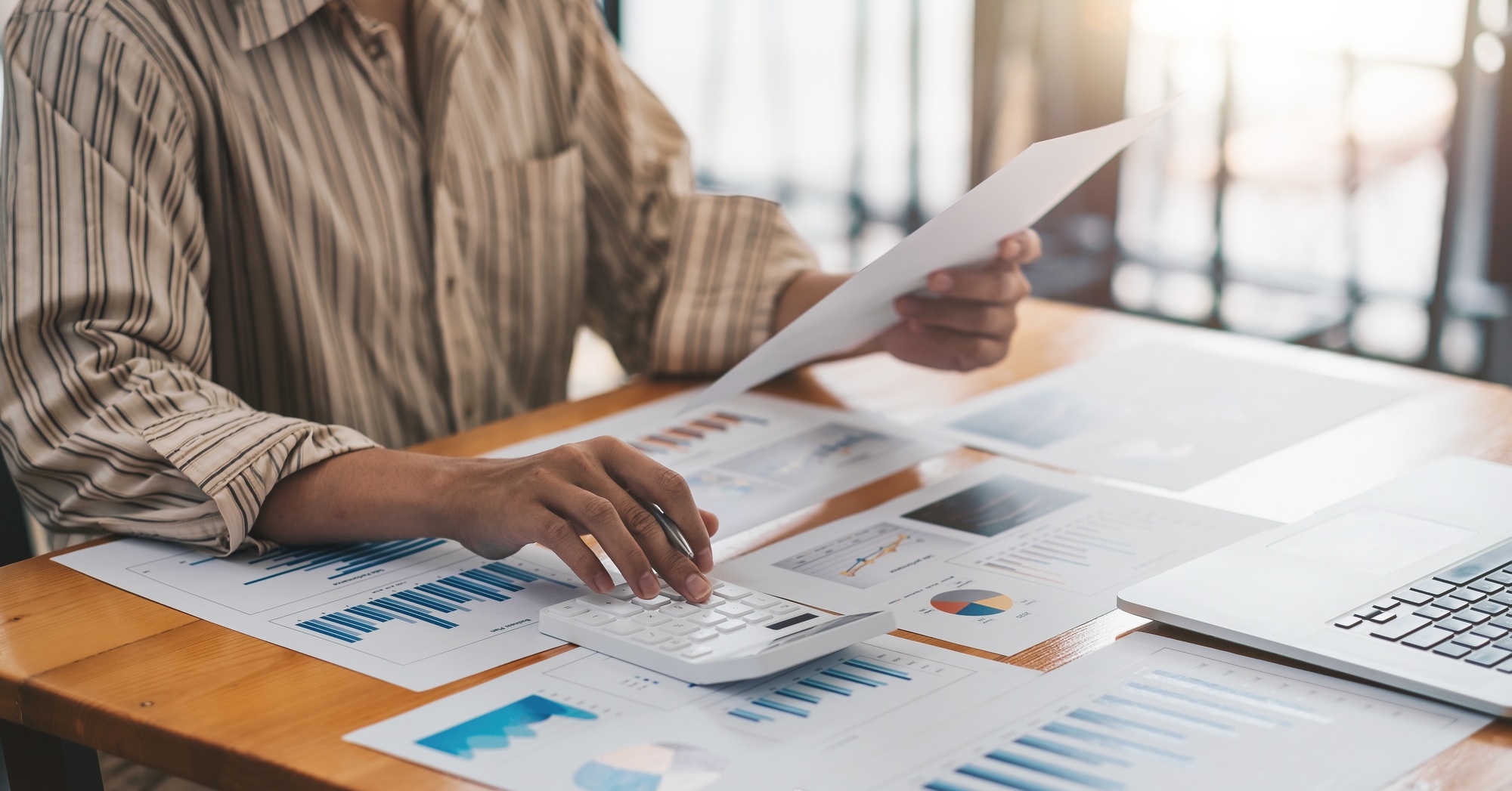 Business accounting concept, Business man using calculator with computer laptop, budget and loan