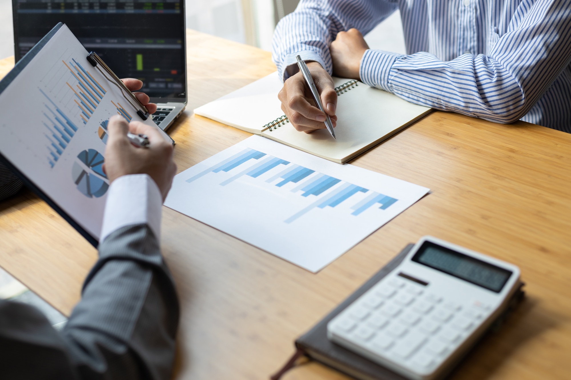 Business advisory meeting to discuss analysis of business growth charts and financial data.