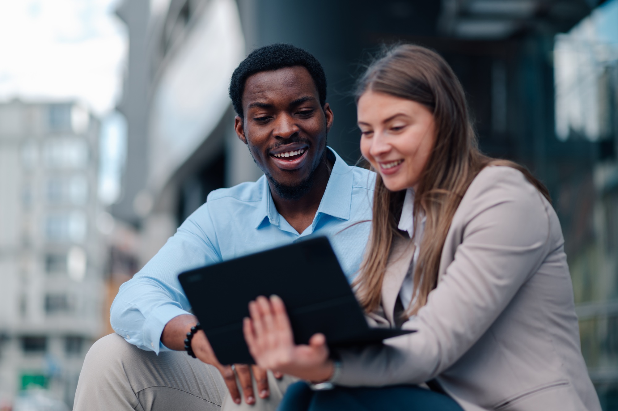 Business colleagues collaborating on tablet in urban setting