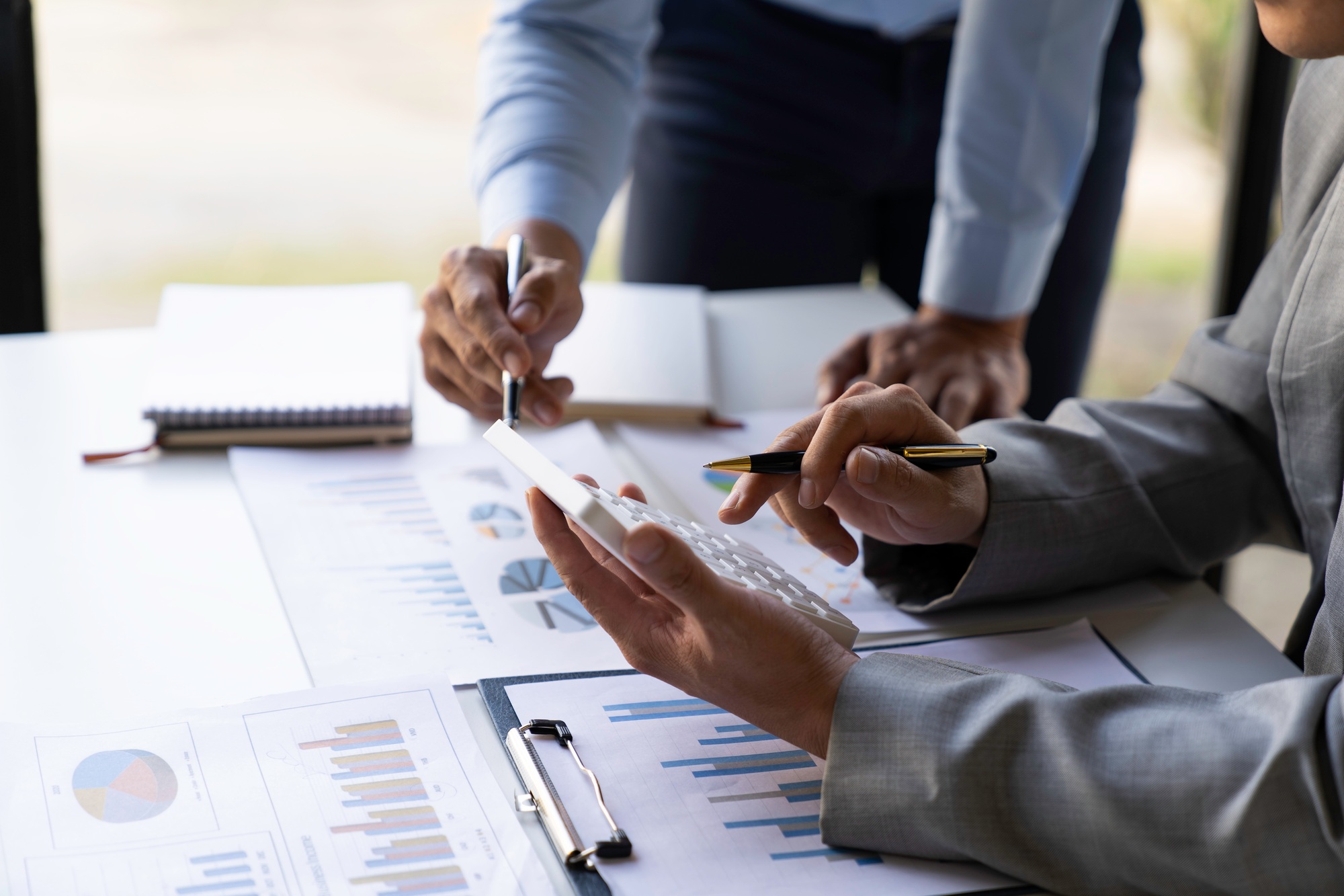 Business executives analyze data documents and calculating about fee tax at an office Image of busin