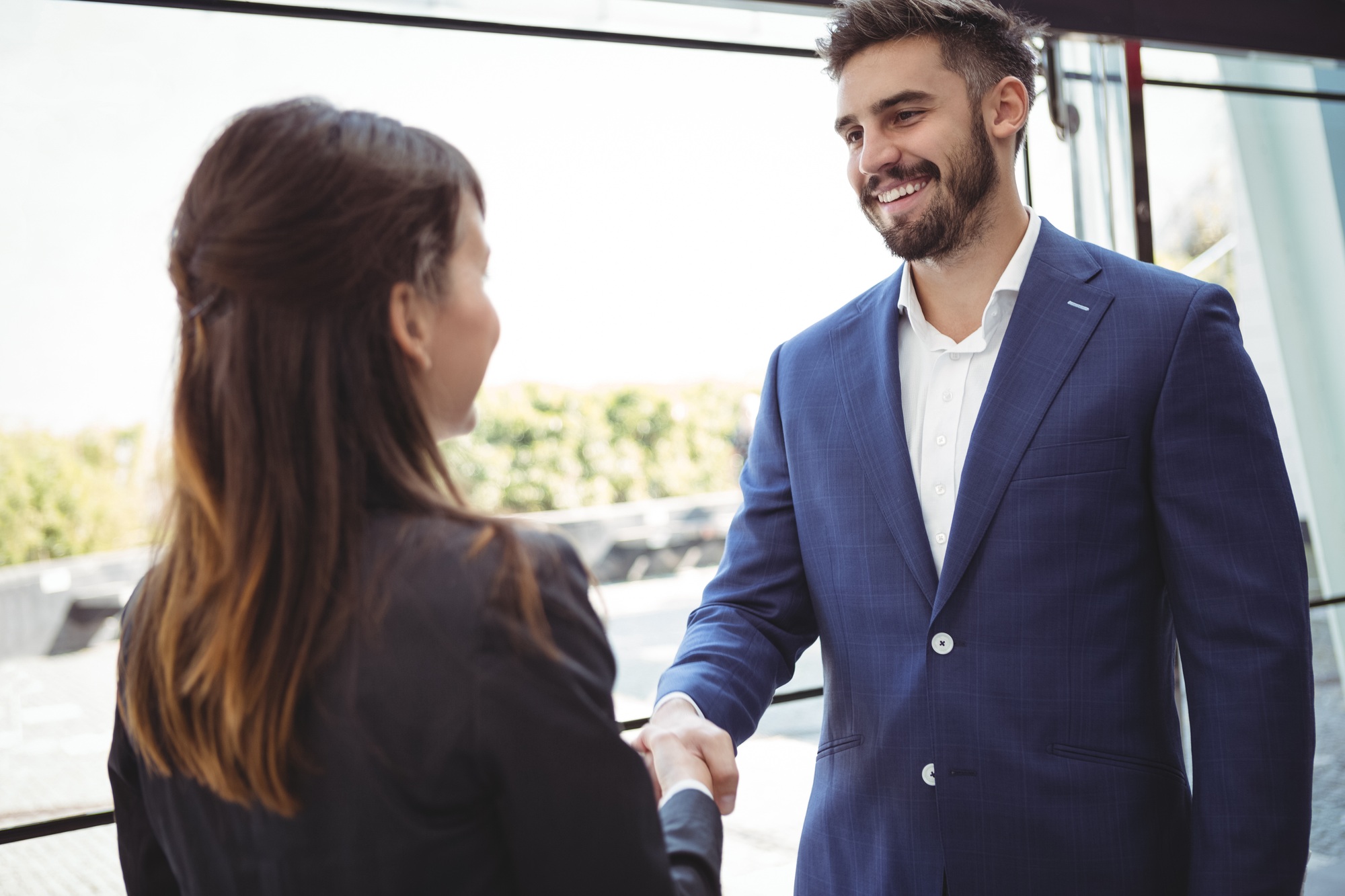 Business executives shaking hands on platform