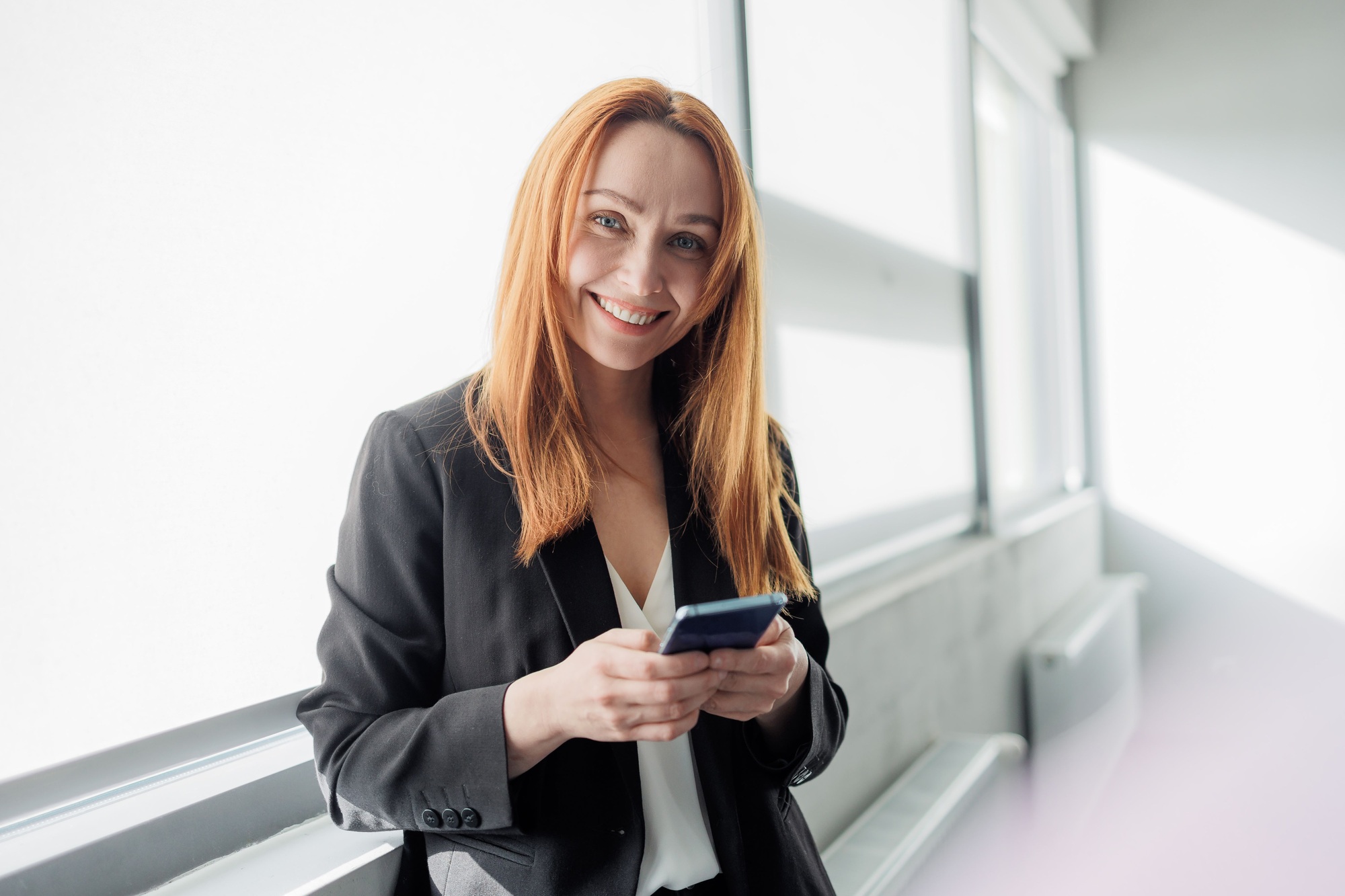 Business lady with a phone, managing a business, listening for training, communication concept