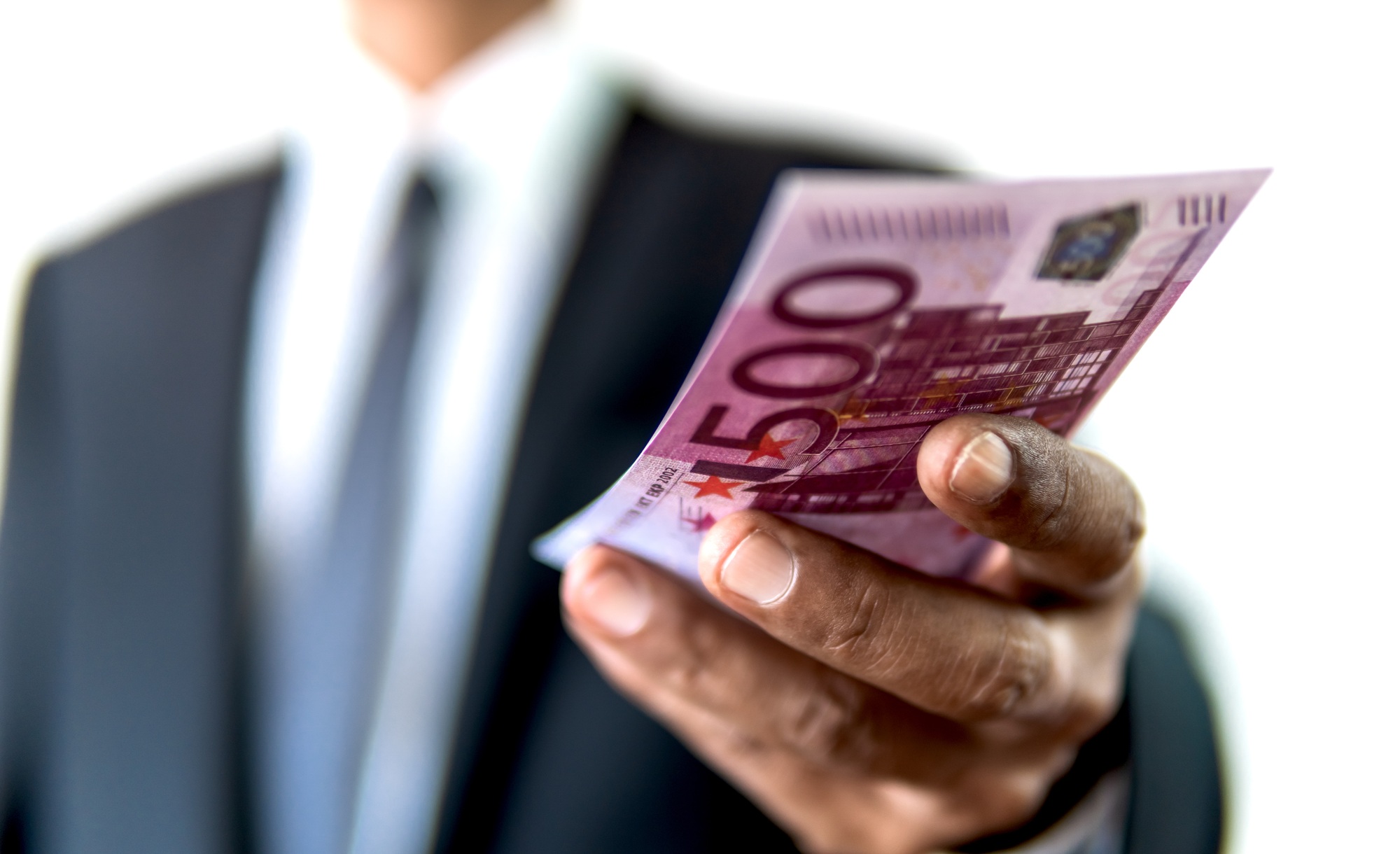 Business man holding five hundreds Euro in hand for payment or giving cash financial