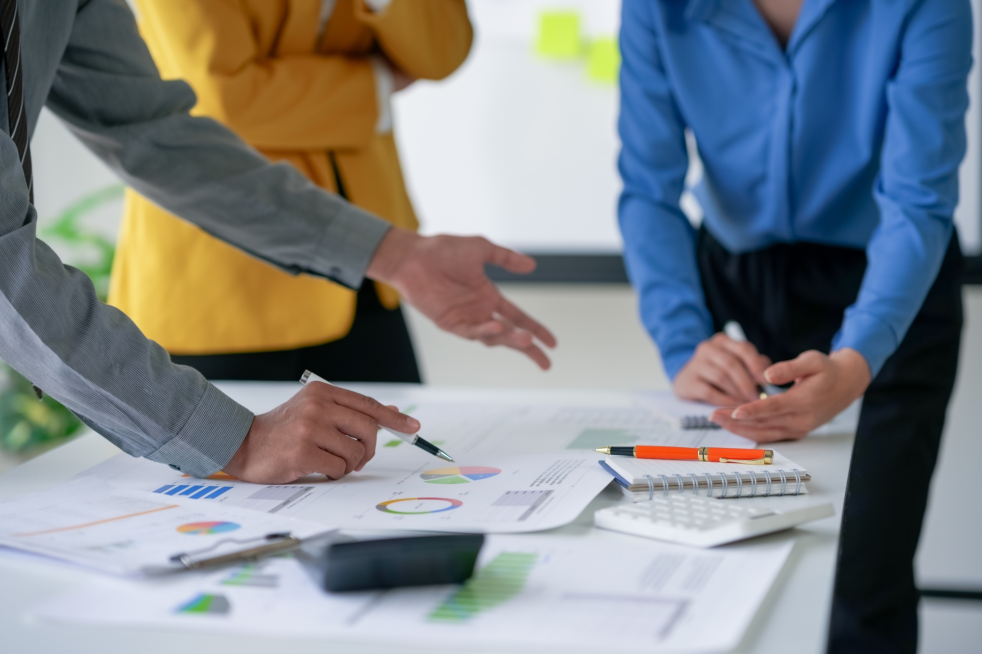 Business meeting with professionals analyzing charts and graphs.