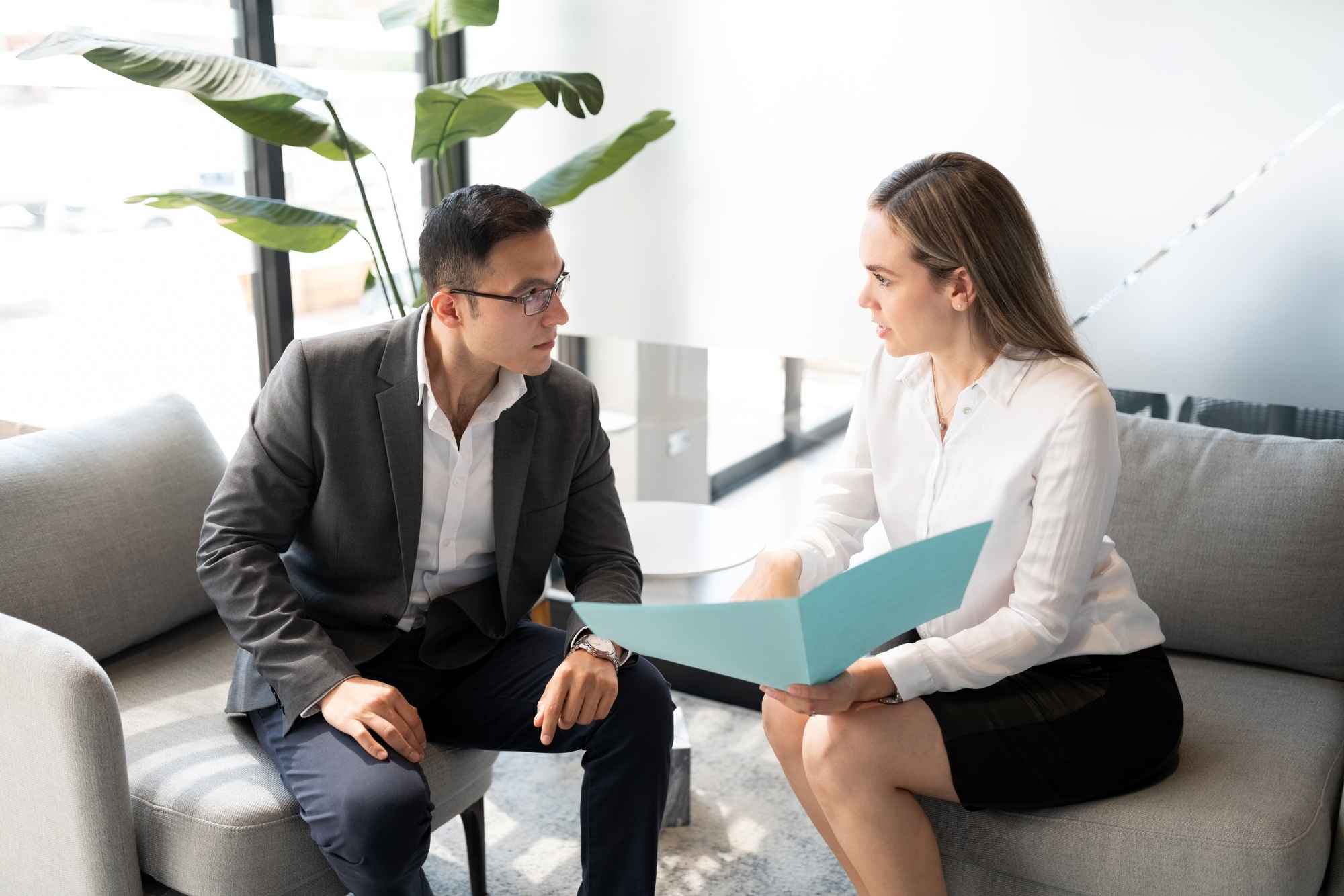 Business partners discussing over a file