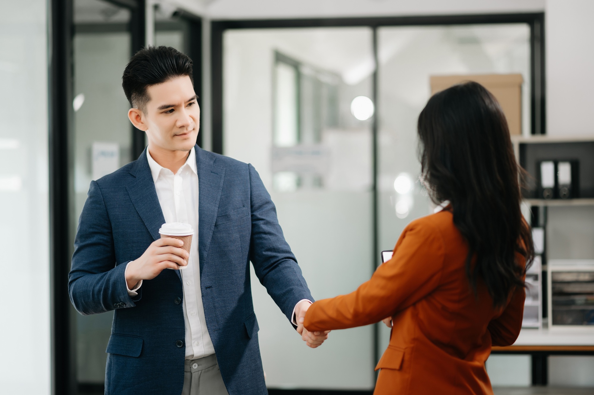 Business partnership handshake concept.Photo two coworkers handshaking process.