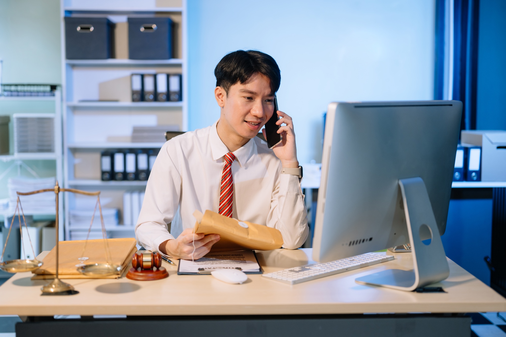 Business professional in suit discussing legal documents over phone, showcasing