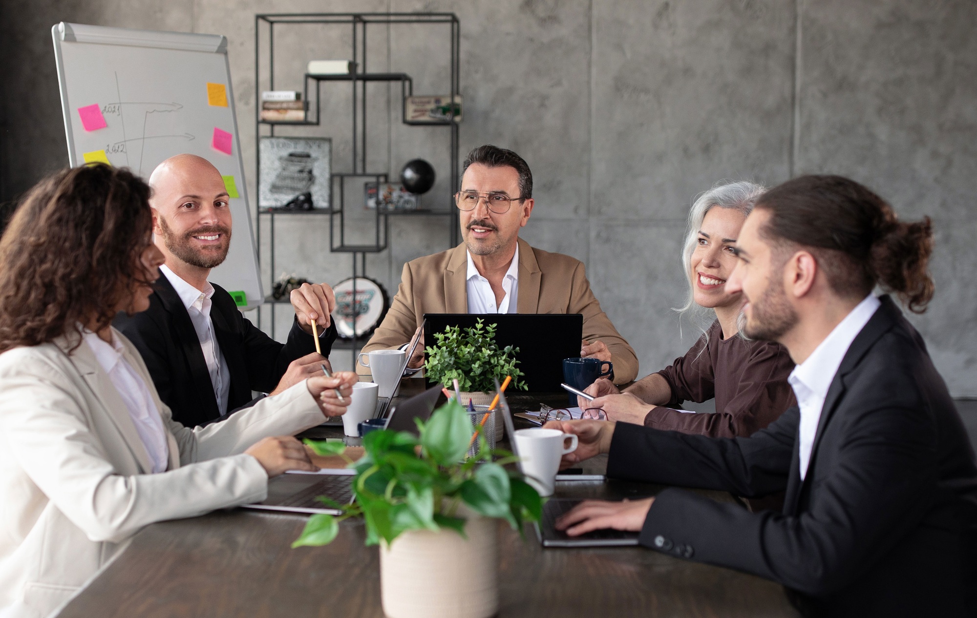 Business team strategizing in a meeting at table in office