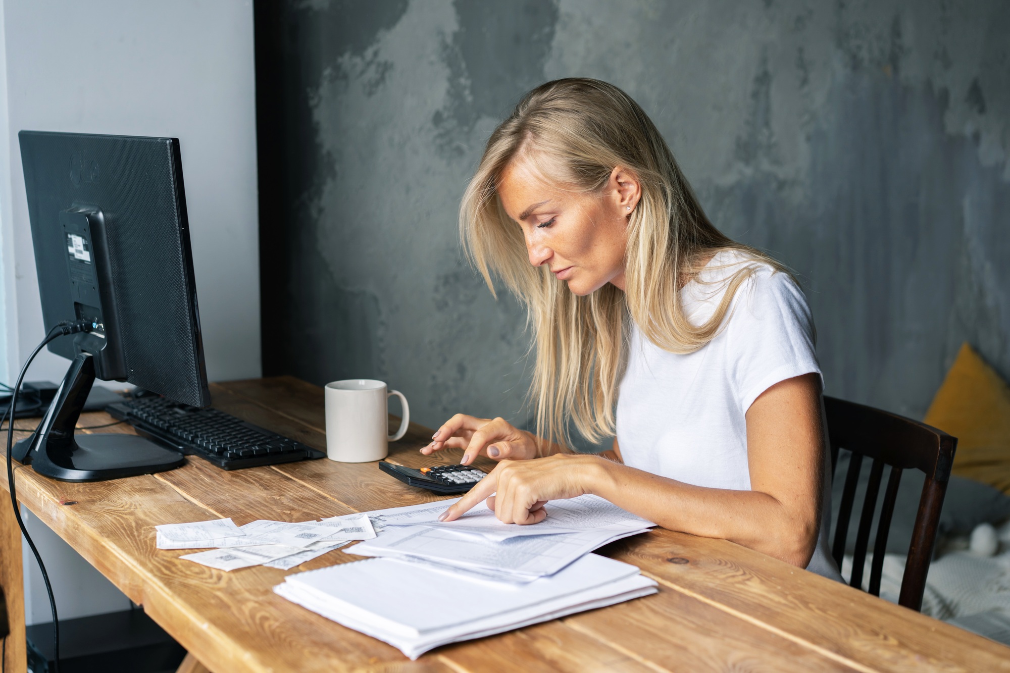 business woman at her desk does the bookkeeping, settles bills and controls the business