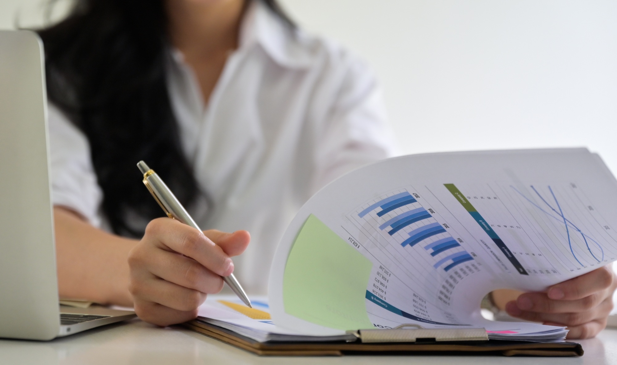Business woman checking company performance report.