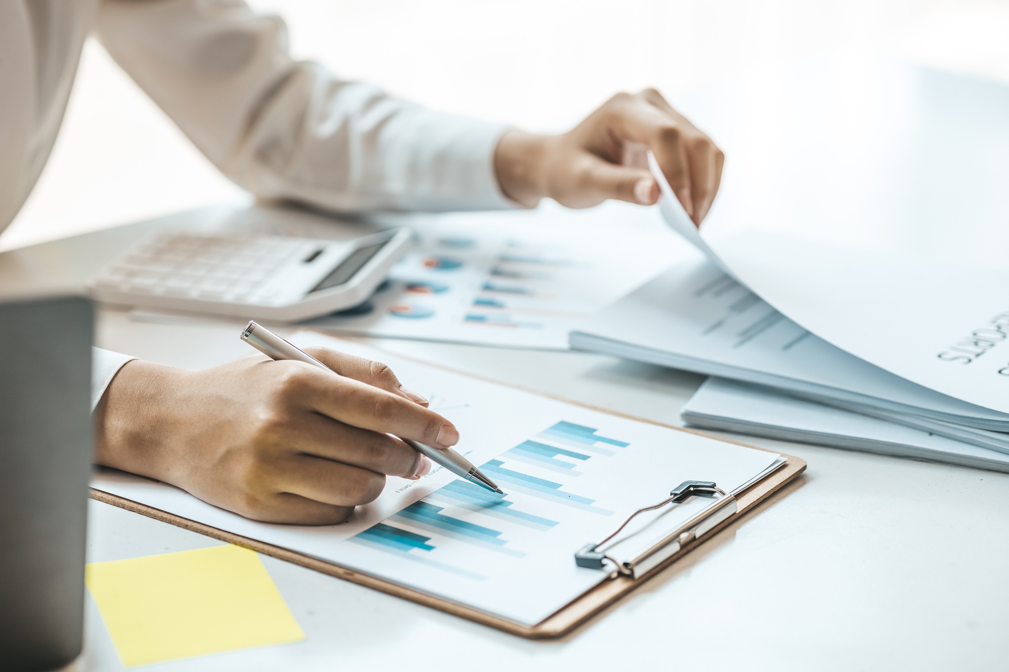 Business woman checking financial documents, she owns a startup company.