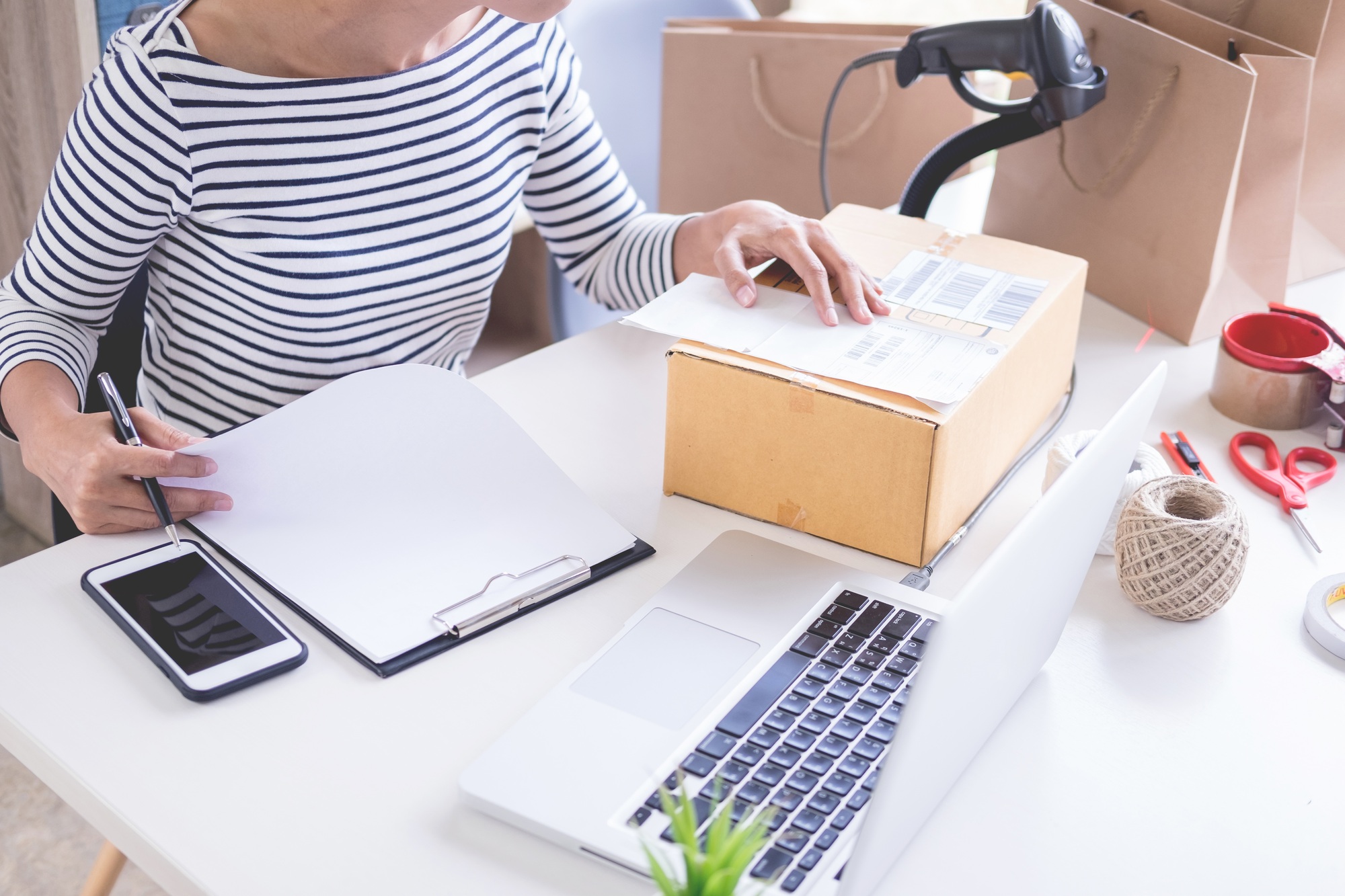 Businessman entrepreneur Shop owner check Order or list inventory in stock which to be delivery