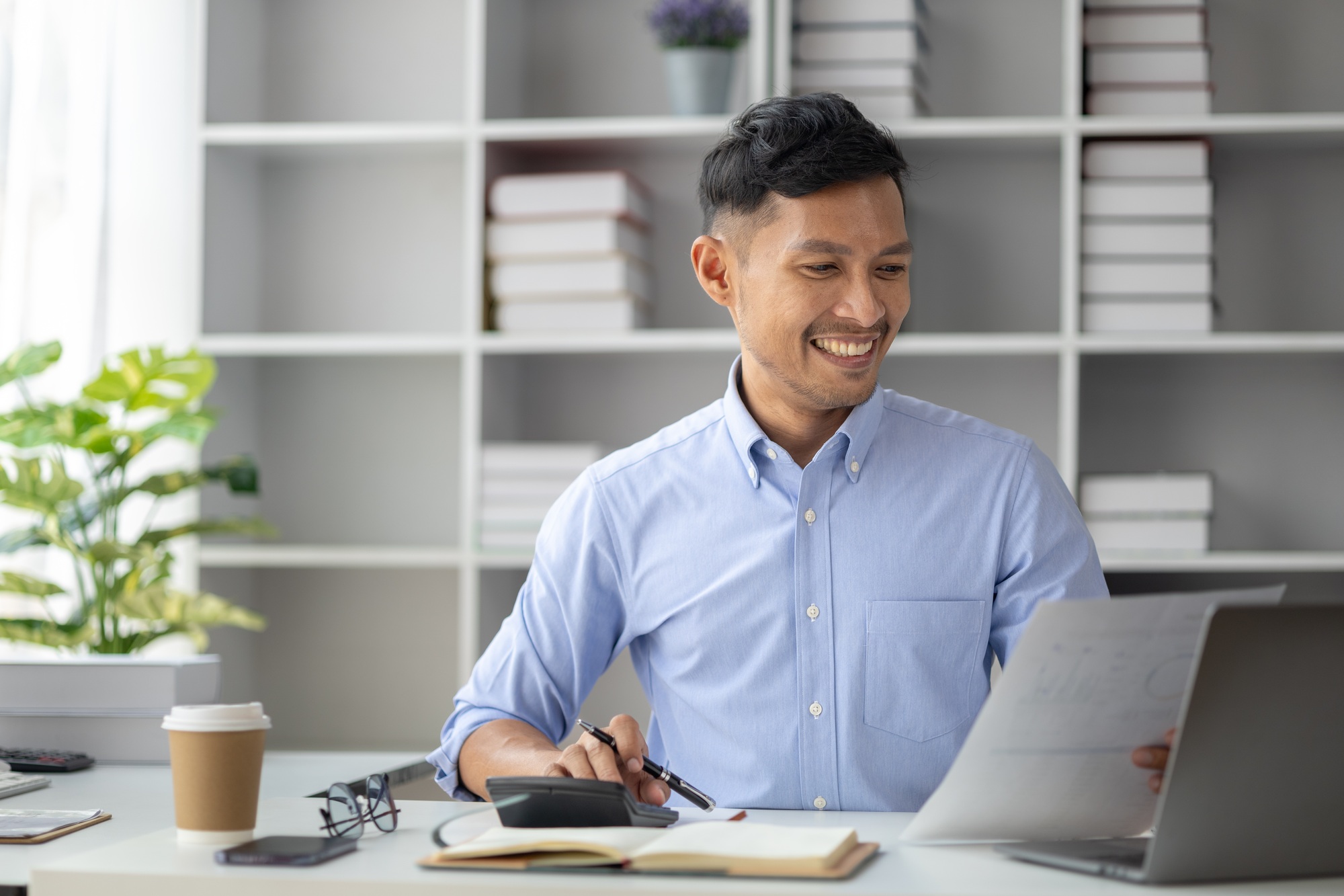 Businessman in a startup office, he is working on management and marketing planning for a leading an