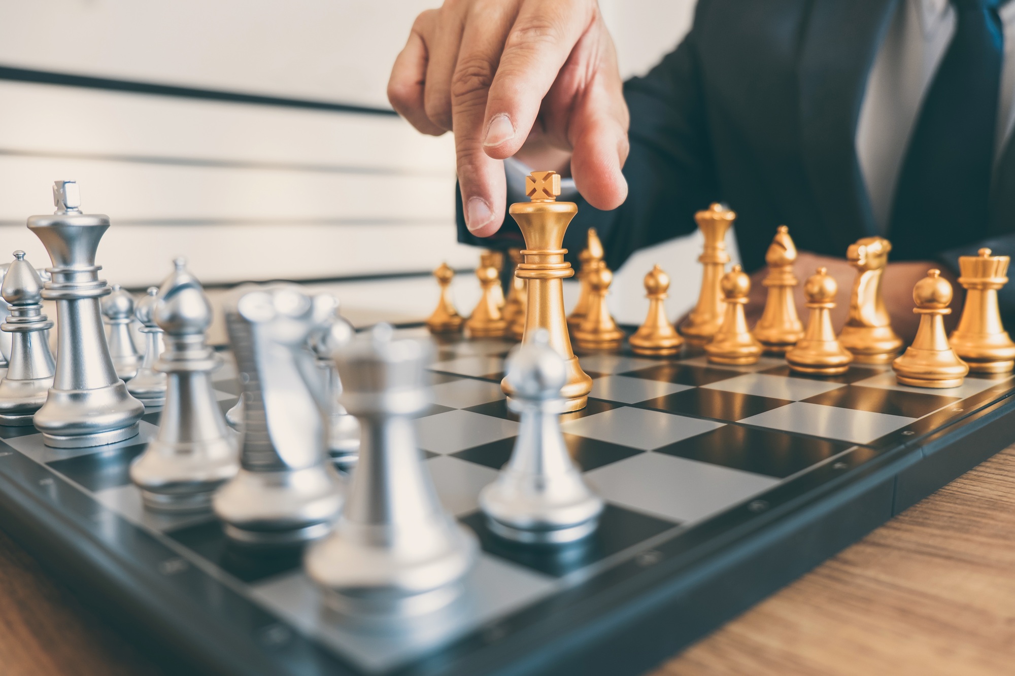Businessman leadership playing chess and thinking strategy plan about crash overthrow the opposite