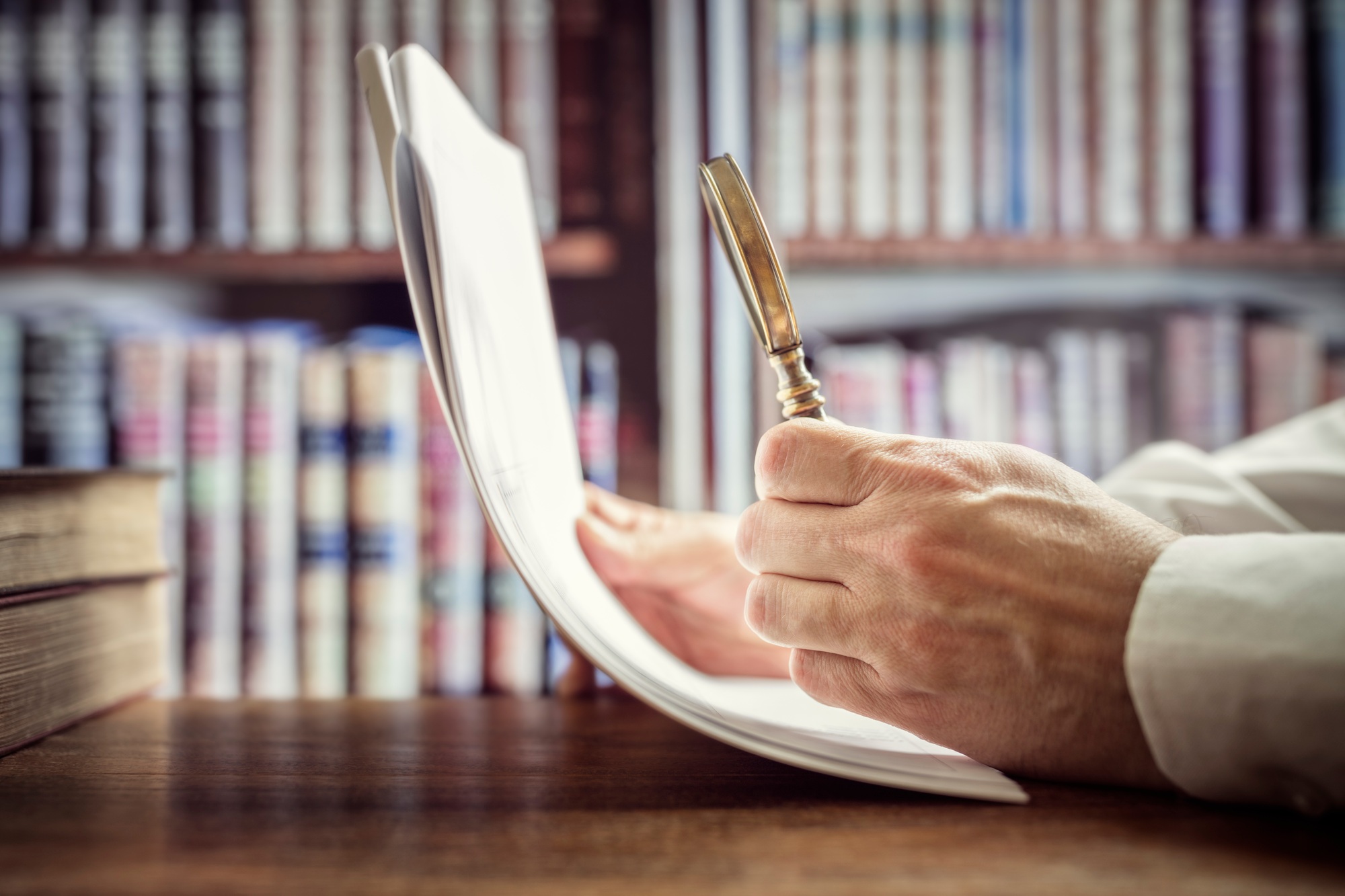 Businessman or attorney with magnifying glass reading documents