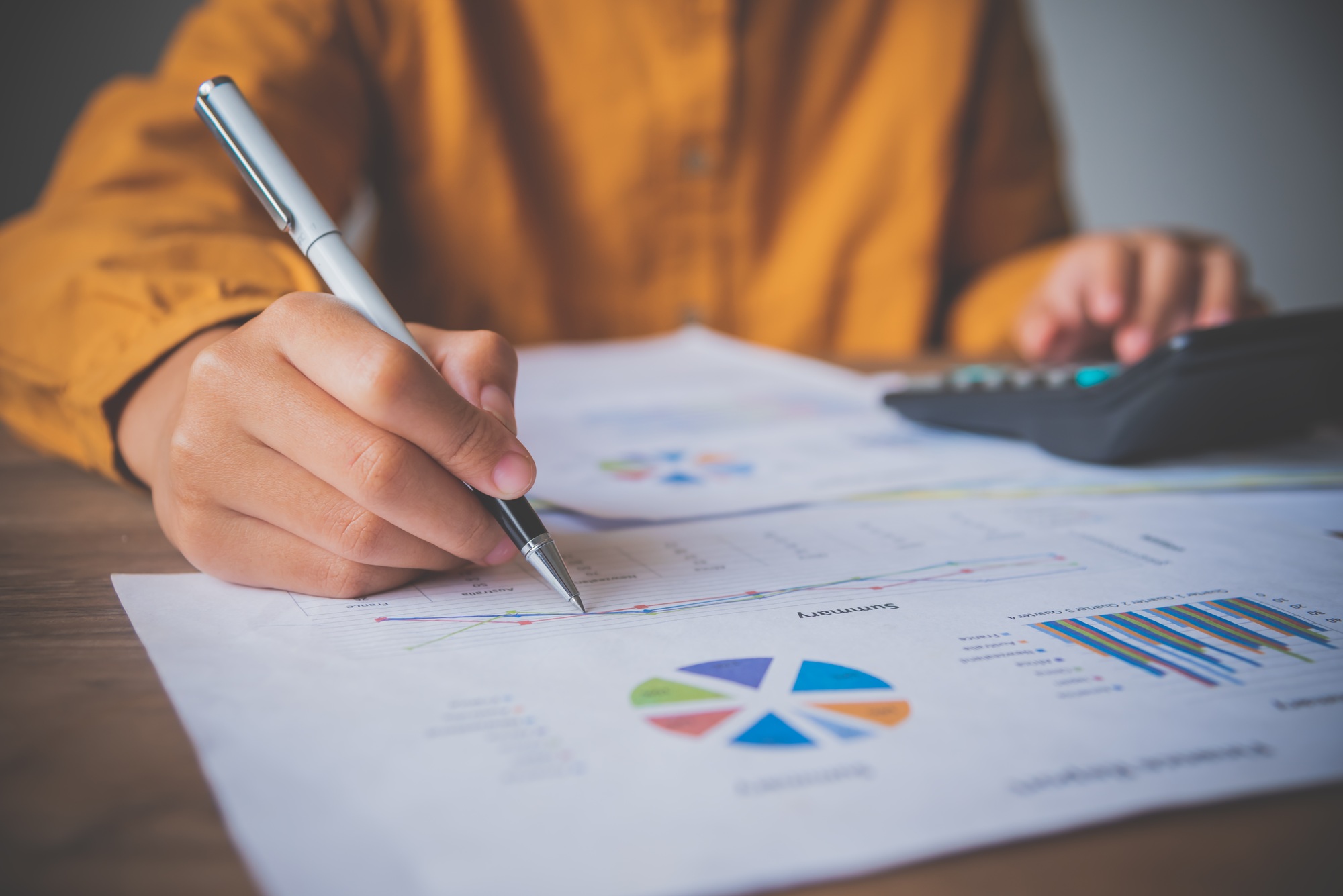 businessman pointing with pen on business report chart are working on accounts in business analysis