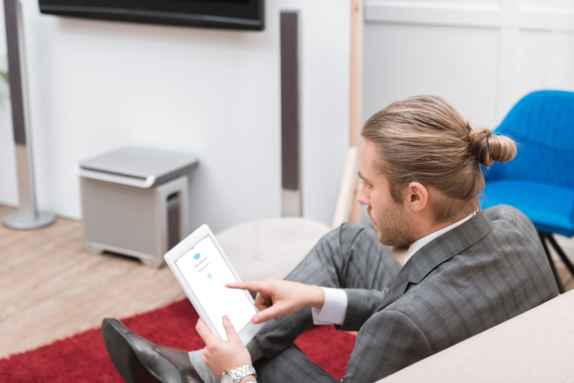 businessman using digital tablet with skype website at home