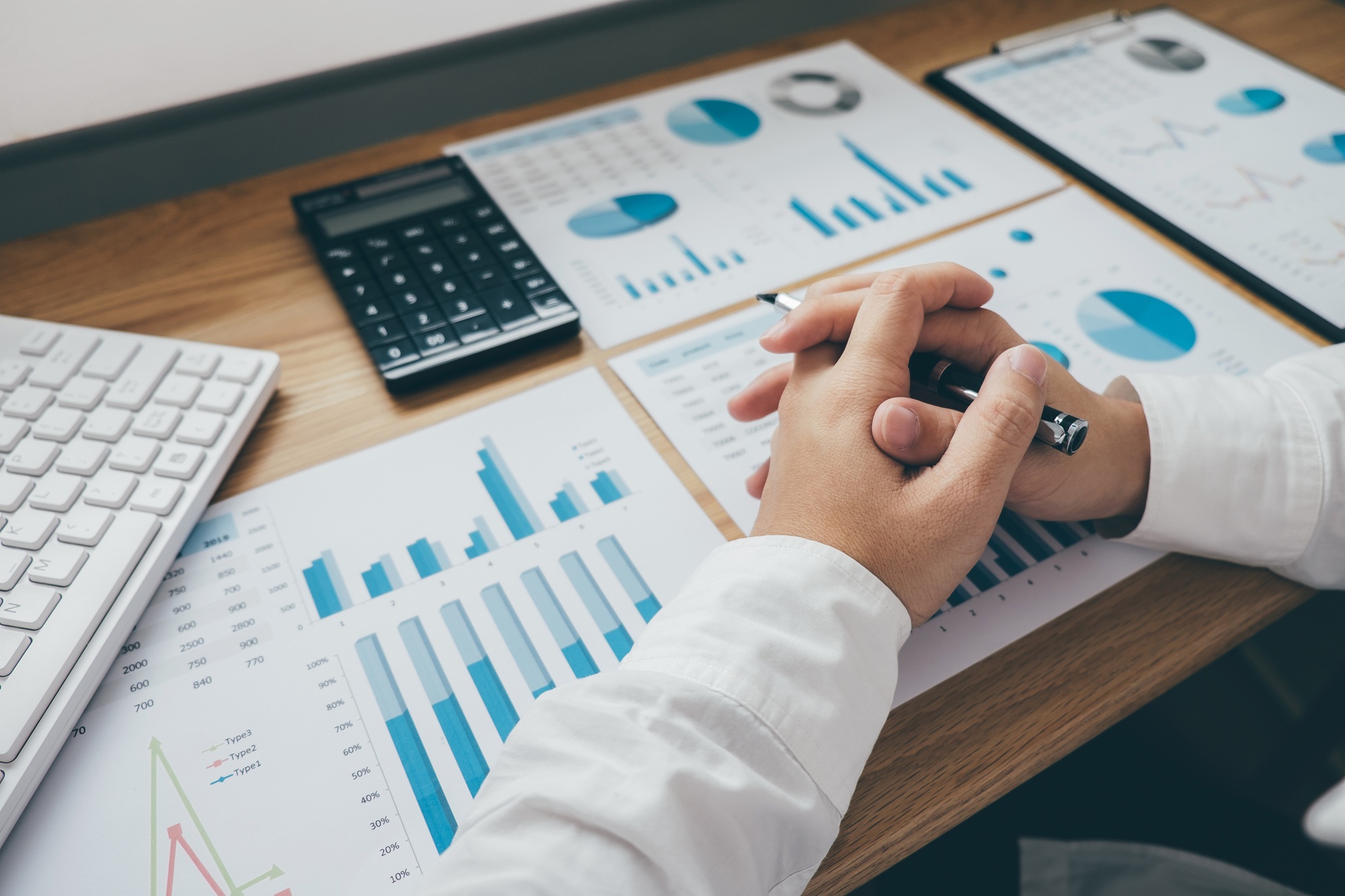 Businessman working on a graph document financial report and analysis calculation investment cost