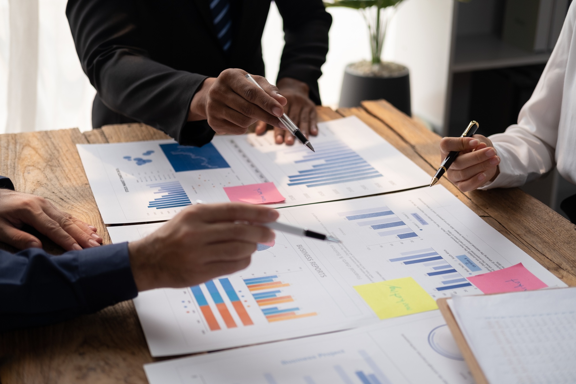 Businessmen are brainstorming for business investment strategies, charts and documents for business