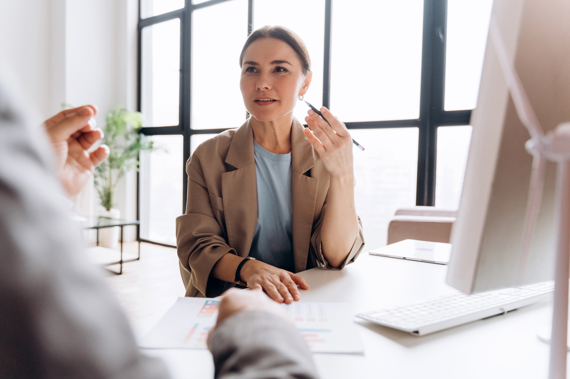 Businesswoman explaining project to colleague during meeting in office