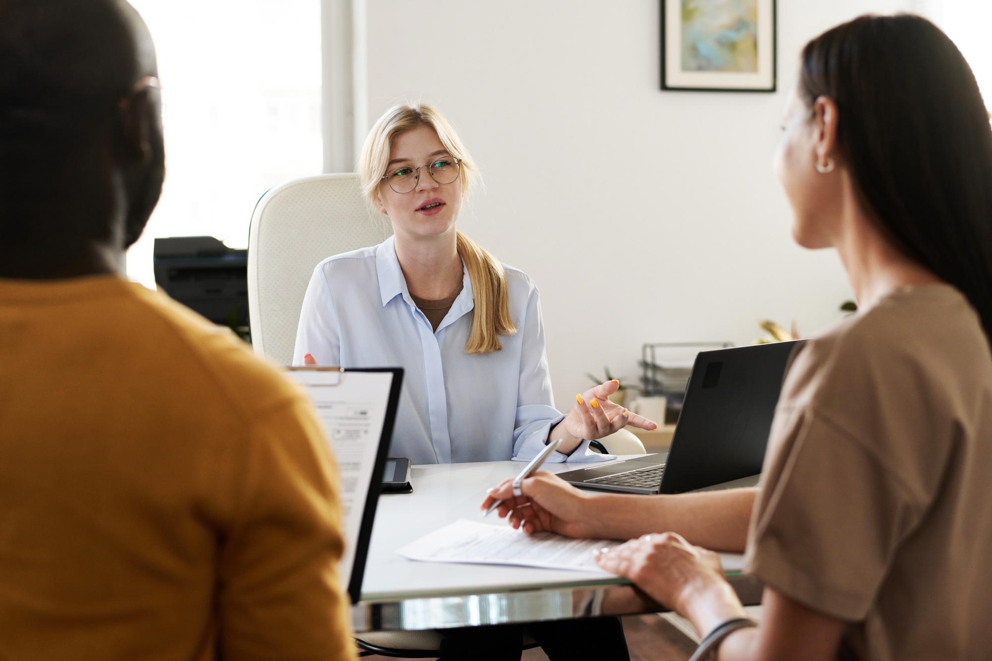 Businesswoman giving consultation to young couple
