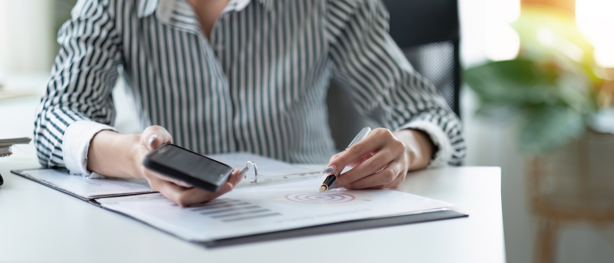 businesswoman hand working with mobile phone and business strategy goal target financial concept