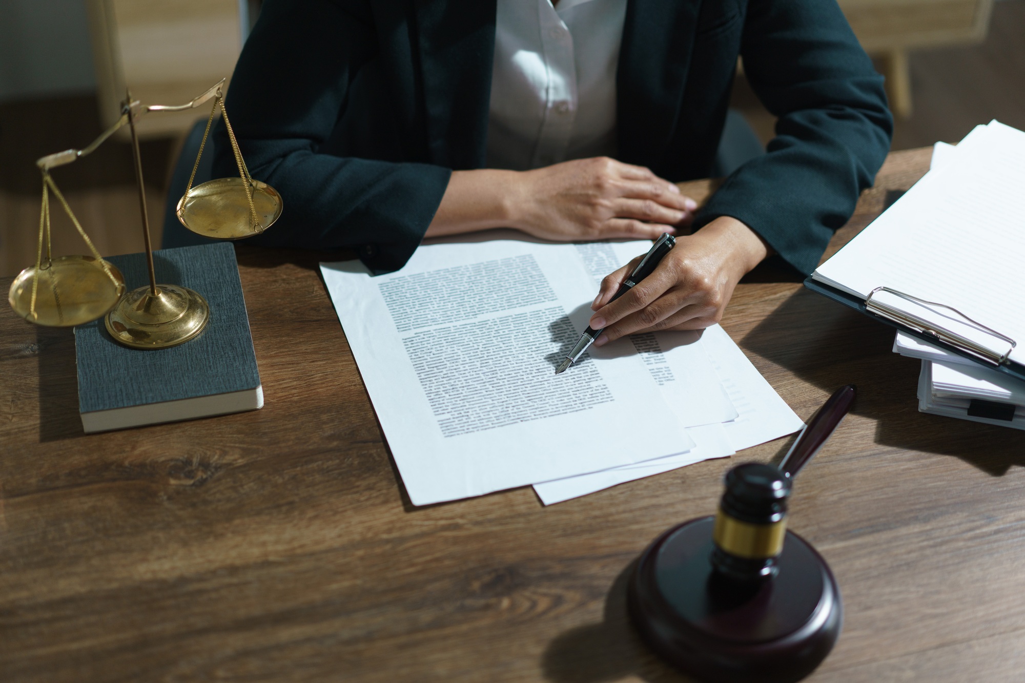 Businesswoman lawyer working and reading agreement business to signing on contract in legal office