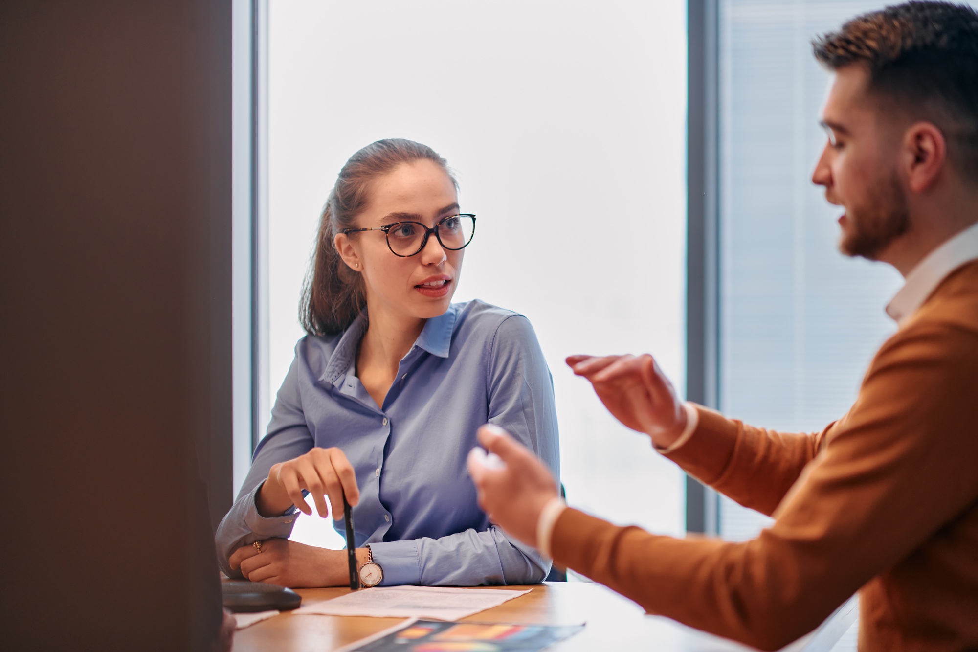 Businesswoman Leading Discussion in Modern Office Setting