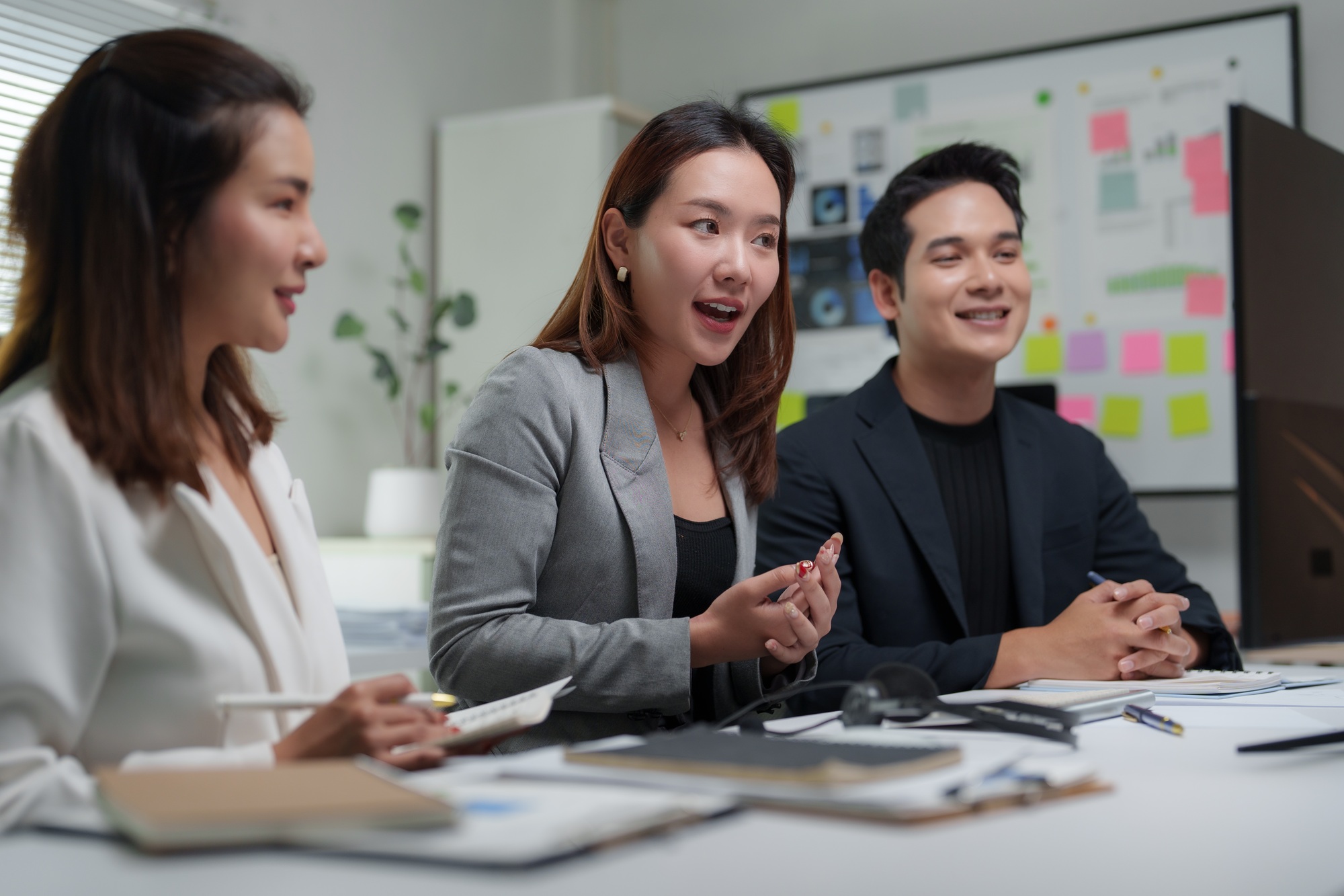 Businesswoman leading meeting with team in modern office