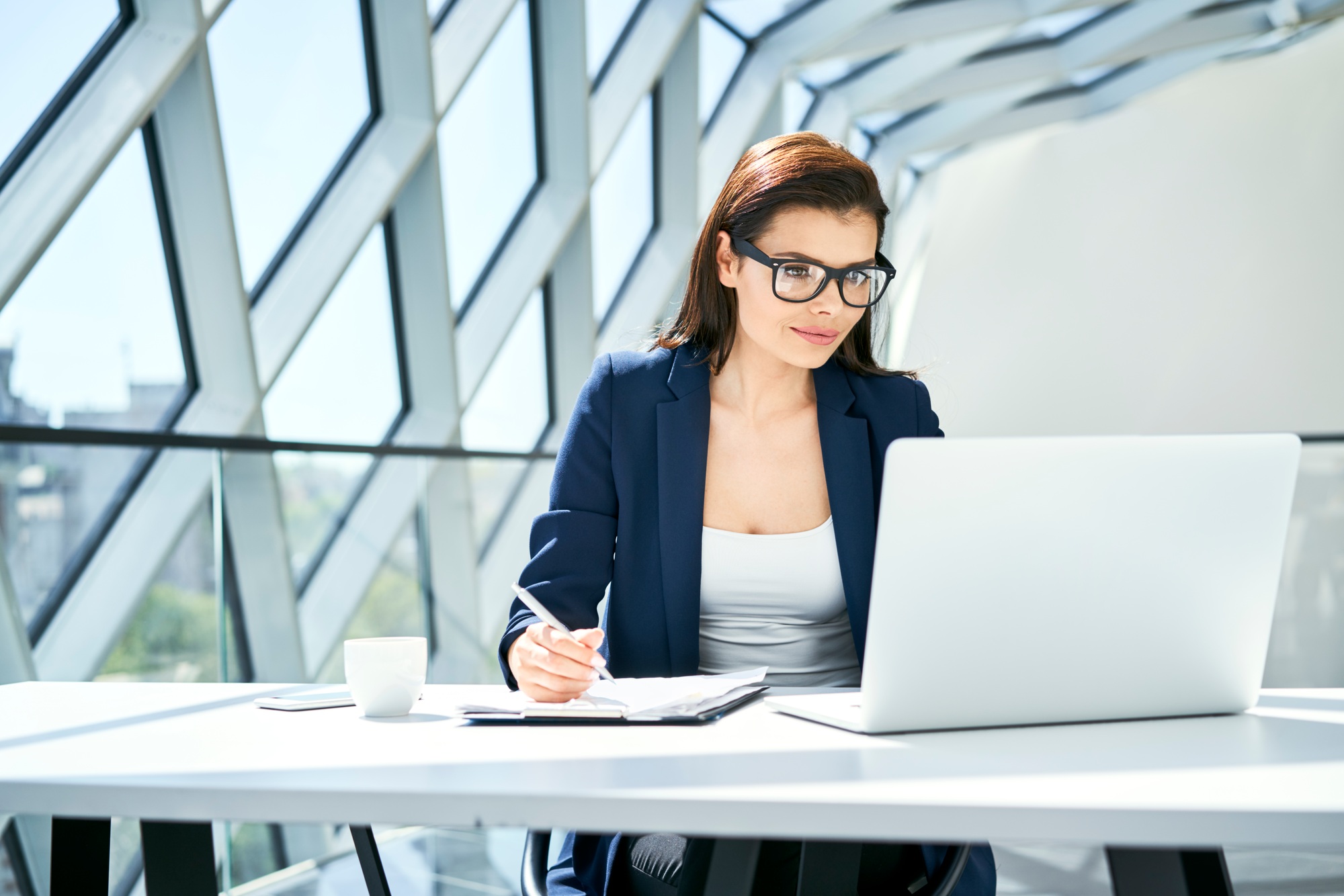 Businesswoman working at desk in modern office