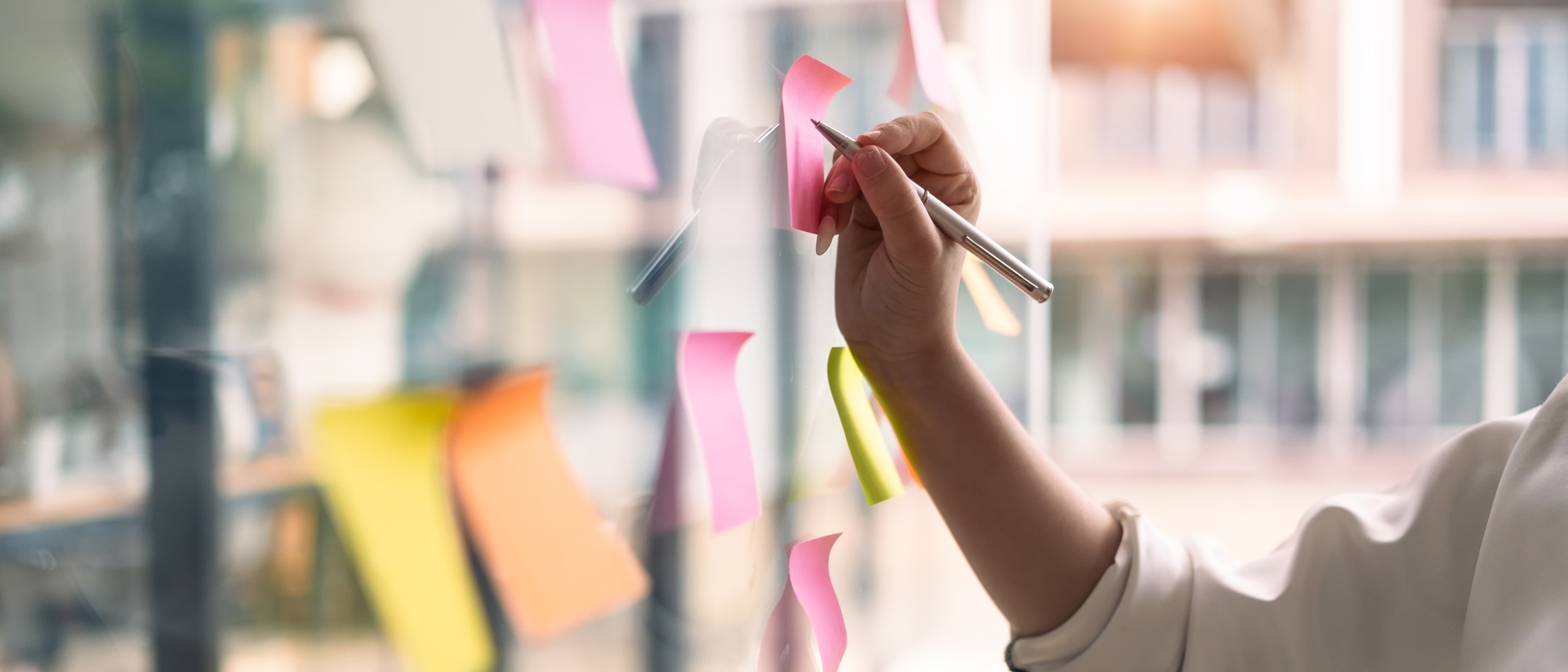 Businesswoman writing information on paper, planning goals, manage corporate work tasks