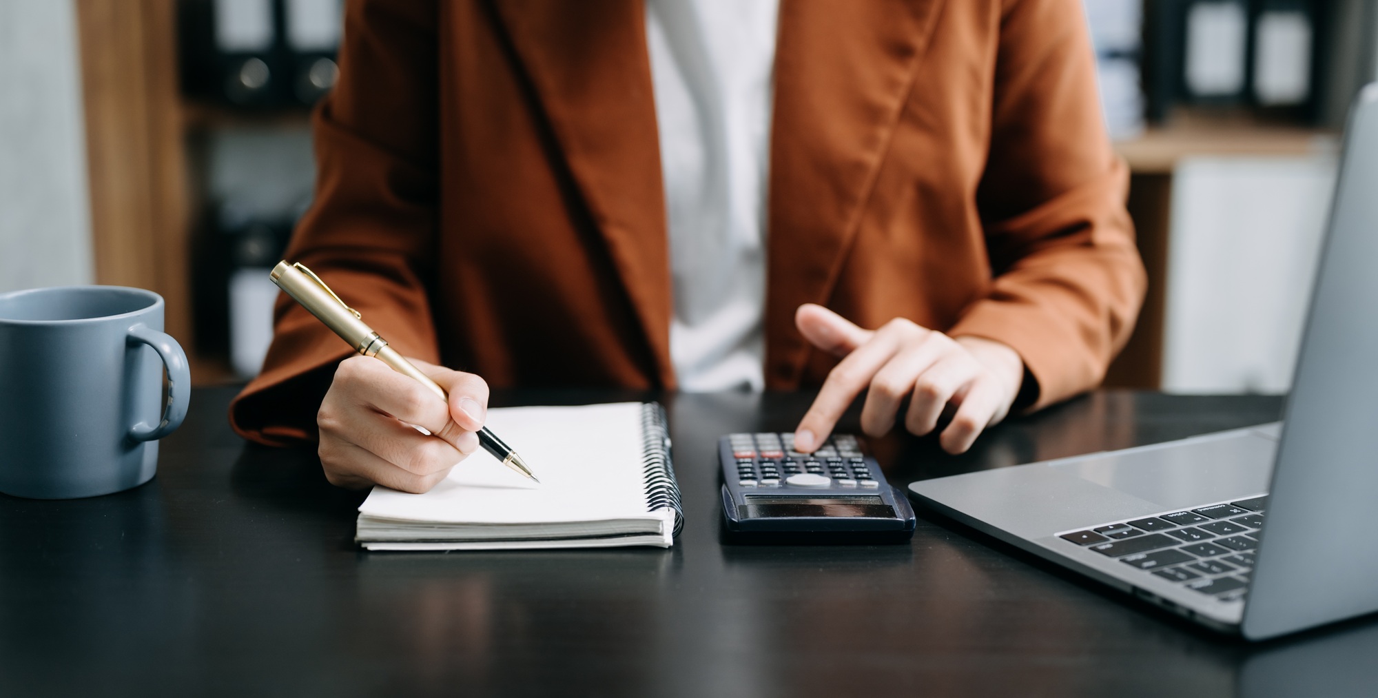Bussinessman analyzing sales data and economic growth and pointing at business report document