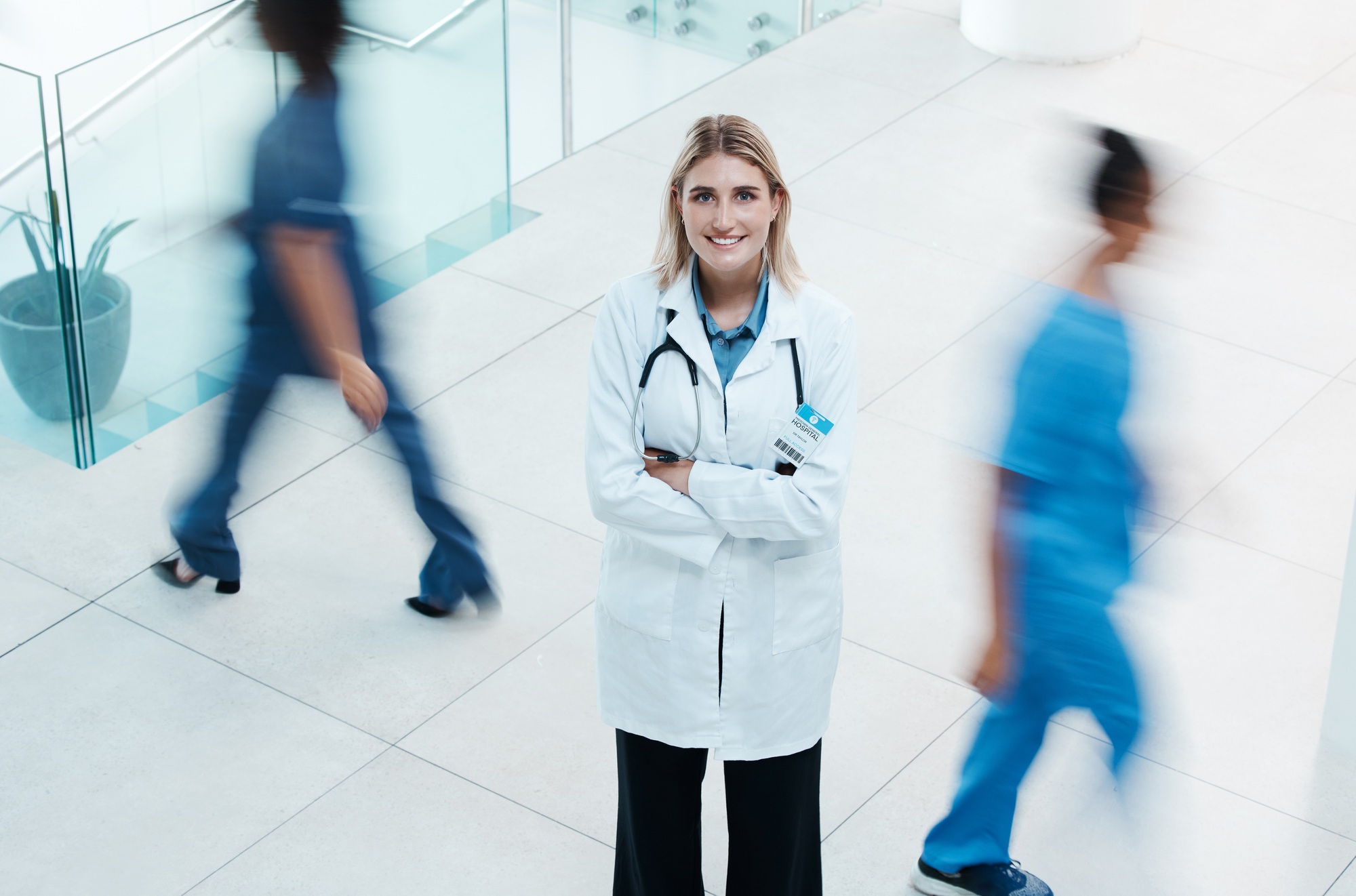 Busy, healthcare and doctor woman in hospital portrait for leadership, trust and leadership with mo