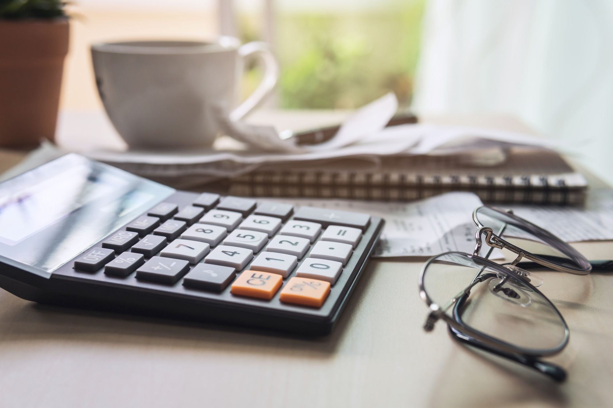 calculator with bills, taxes, bank account balance and calculating home expenses