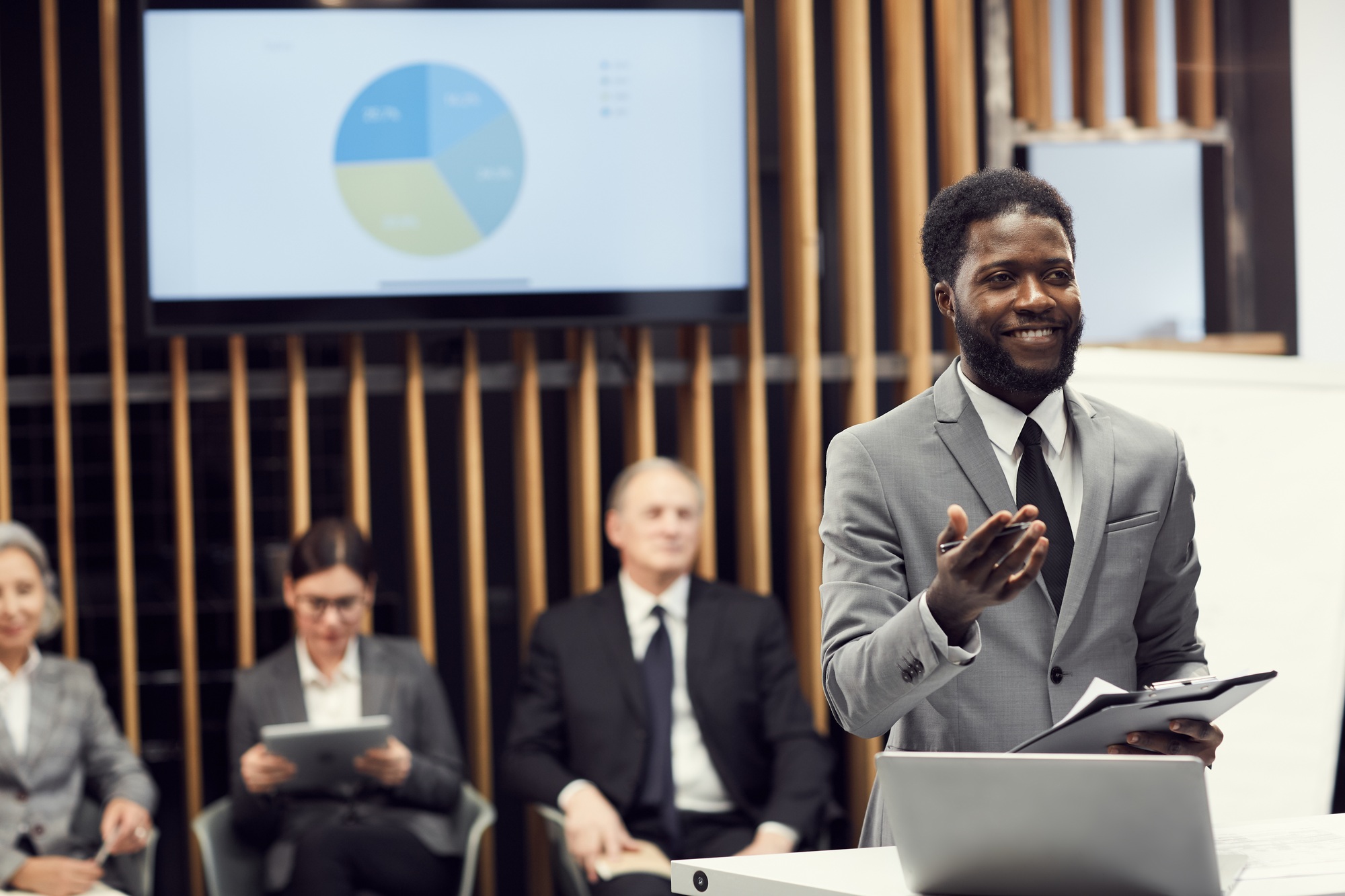Cheerful black businessman sharing development strategy