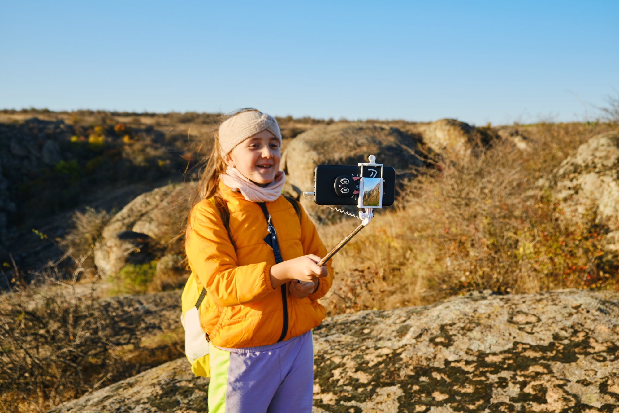 child vlogger filming daily video diary outdoors. kid creating social media content.