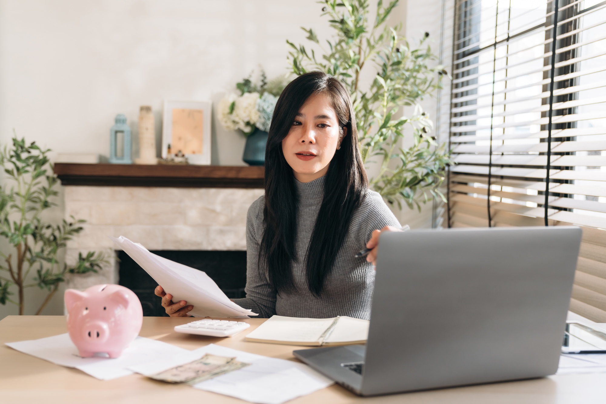 Close up hand of Business woman using laptop while plan and discussion information for financial.