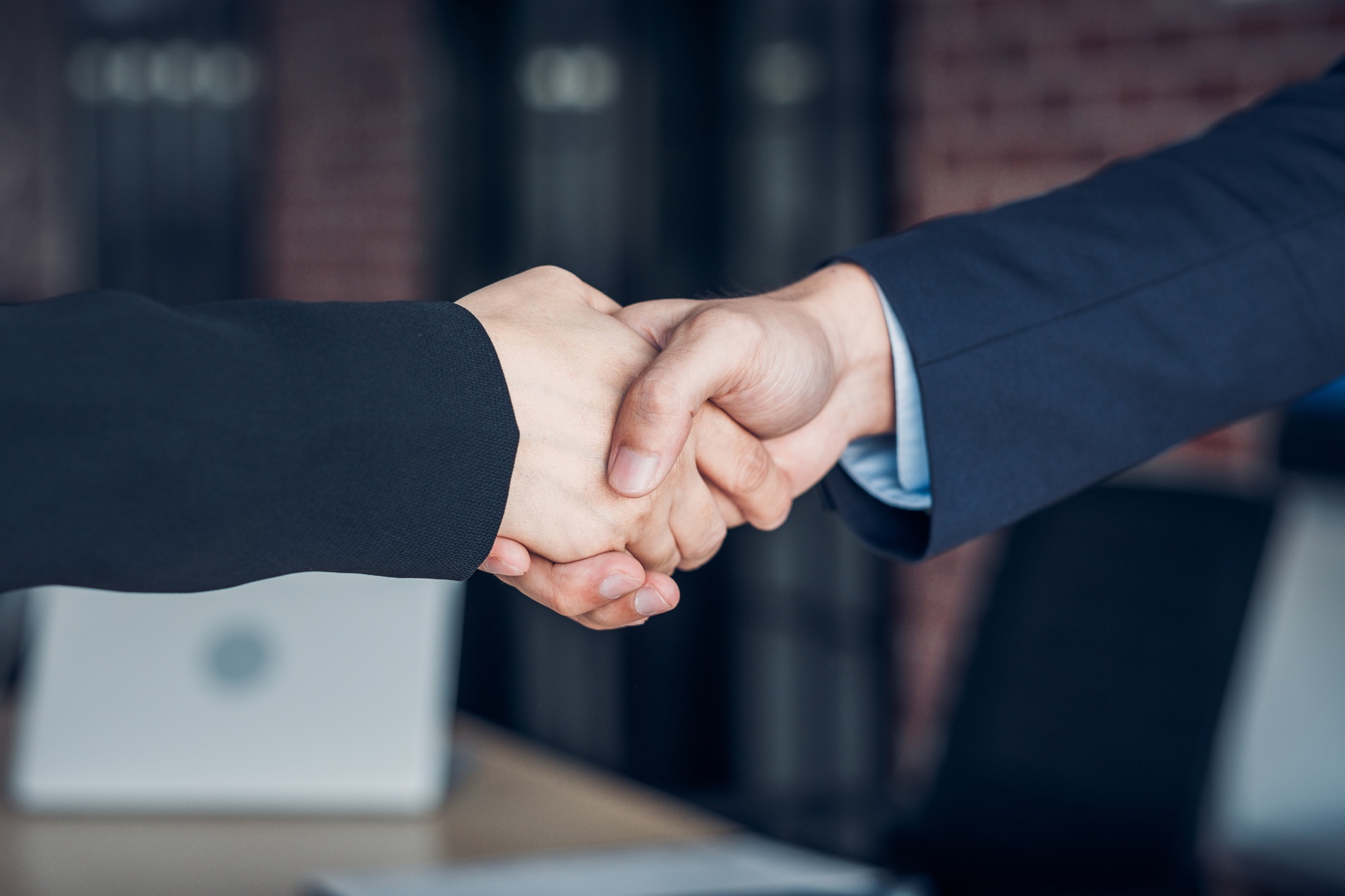 Close up handshake between businesswoman and businessman