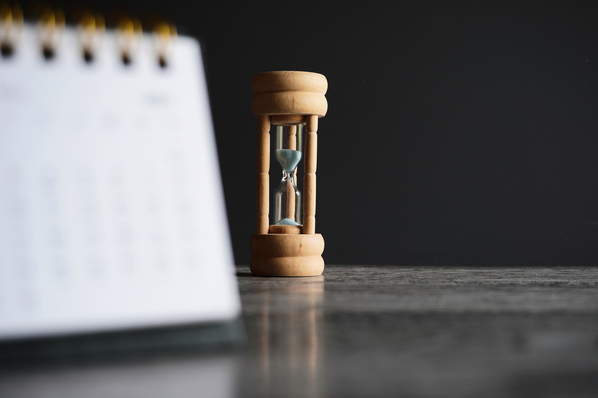 Close up image of calendar and hourglass with copy space.