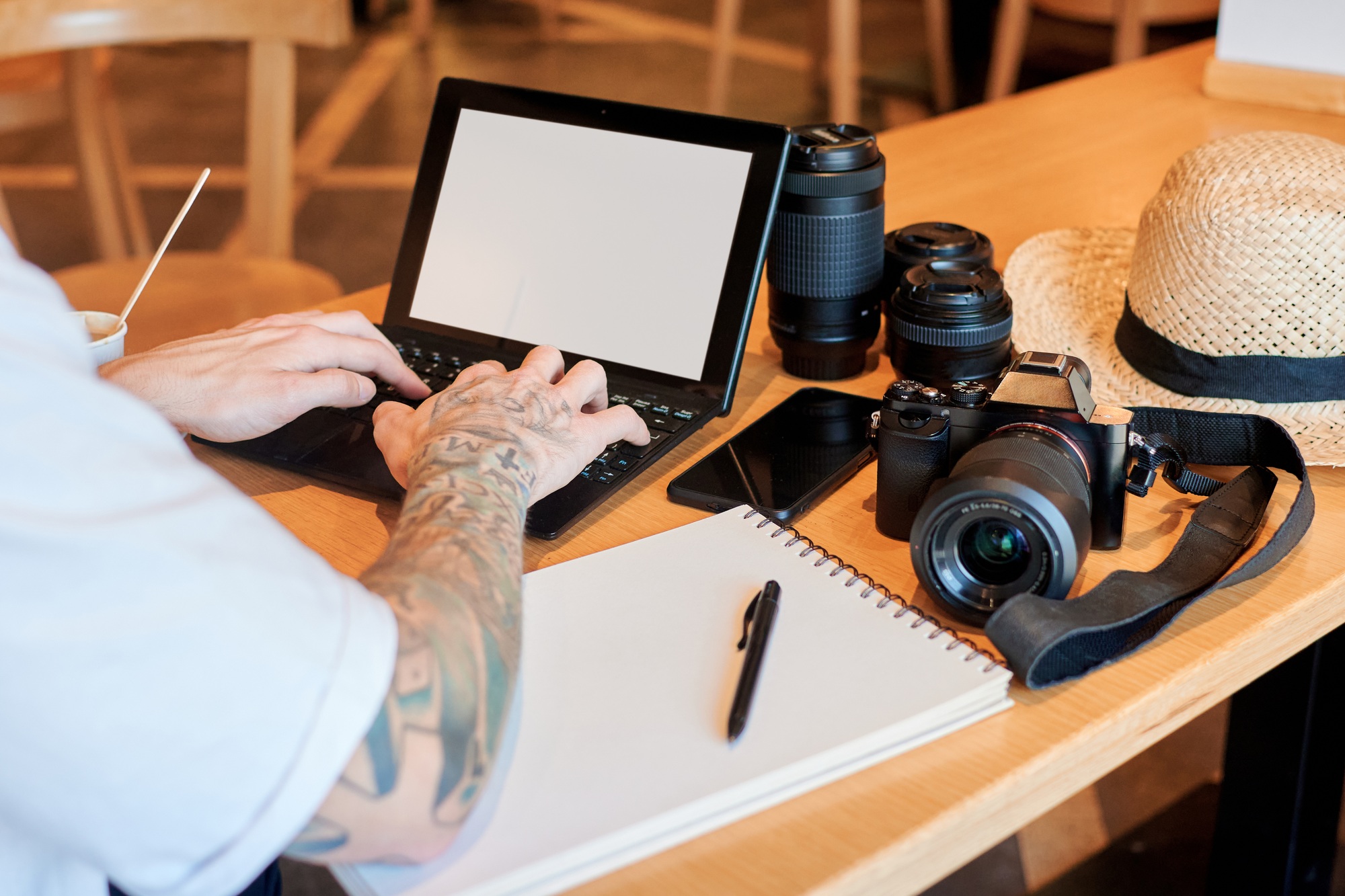Close-up of a photographer working remotely in a coffee shop