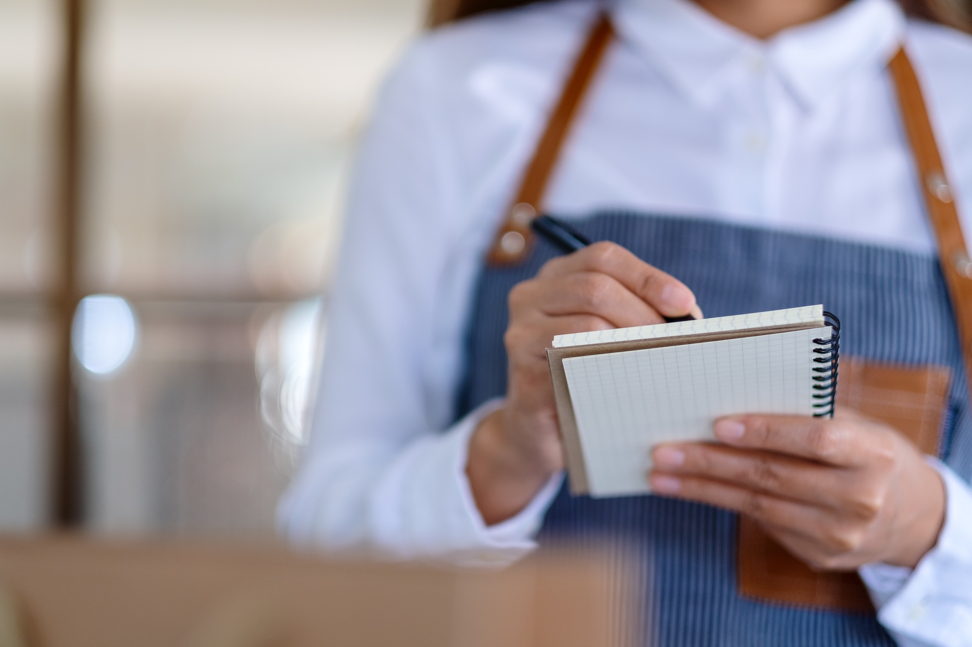 Closeup image of a female entrepreneur checking orders from customer