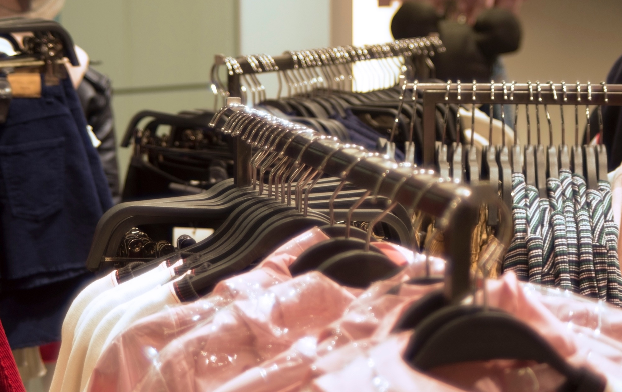 clothes hanging on hangers in the store,