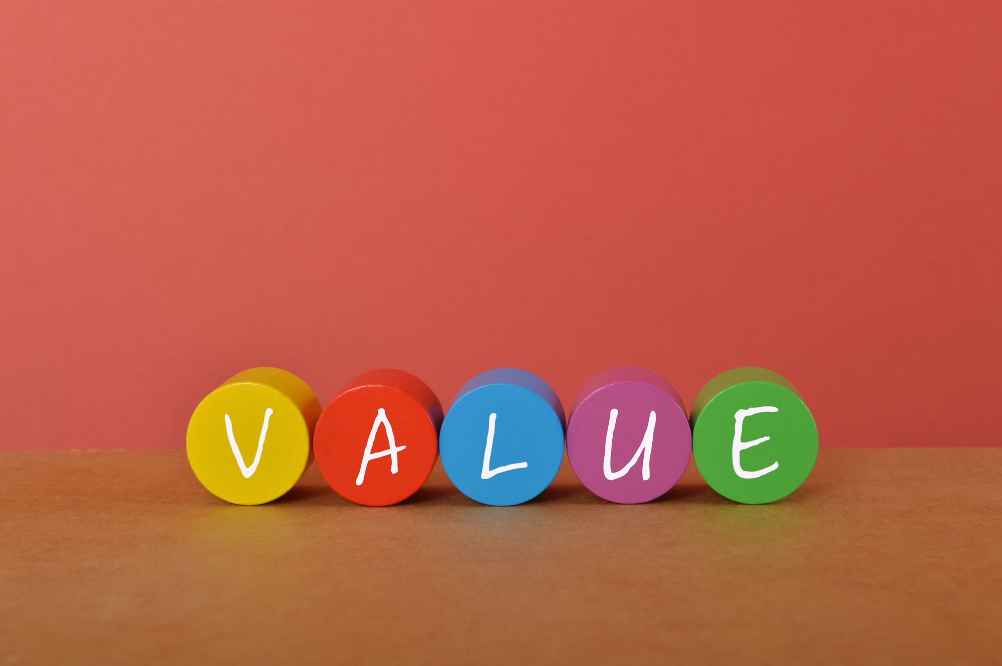 Colorful wooden blocks with text VALUE. Cost of goods sold concept.